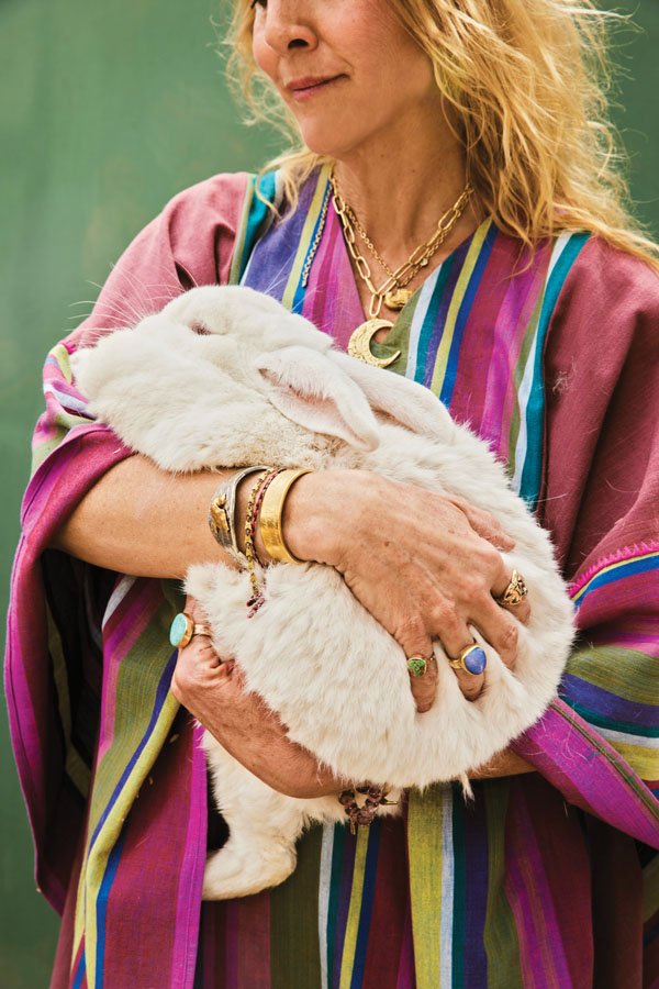  MaHarry, bedecked in her own designs, holds Sally May, one of the family’s rescue rabbits.&nbsp; 
