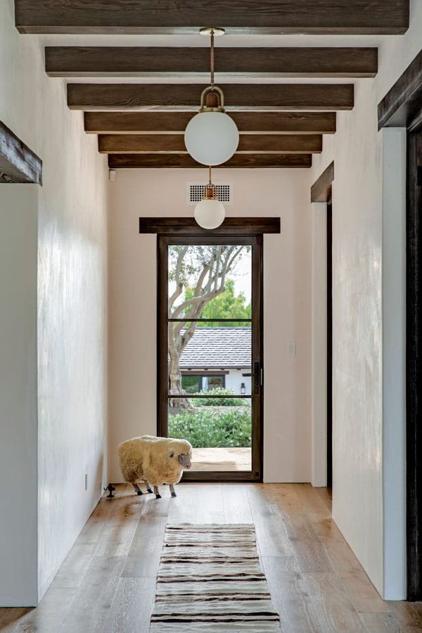  A vintage woolly sheep from 1stDibs guards the hallway. 