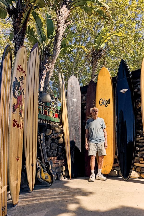  Yater surrounded by his original shapes (left to right): plank, balsa spoon “Lone Wolf,” 7 stringer gun, Fender prototype surf guitar, Balsa Redwood Point, solid redwood Kiko’o, Redwood Picana special, Gidget 58 balsa pig, 10 ft. black Hawaii gun wi