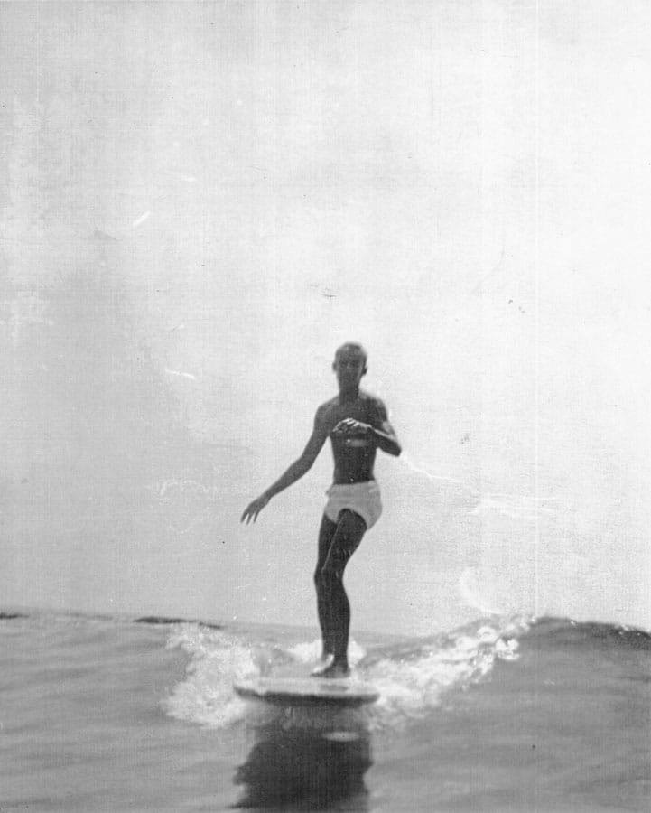  Yater riding Laguna Beach in 1948 on a solid wood plank board. (The board was so heavy that it was a two-man job to get the board to the surf. Once there, they took turns surfing.) 