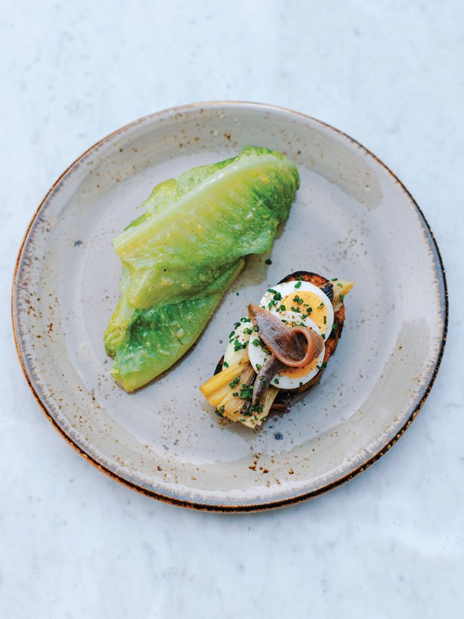  Caesar salad with egg, leek, and anchovy crostini 