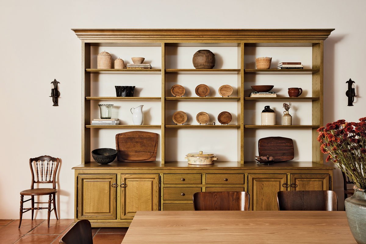  Carefully curated  objets  line shelving in the dining area of The Villa’s chef’s exhibition kitchen 