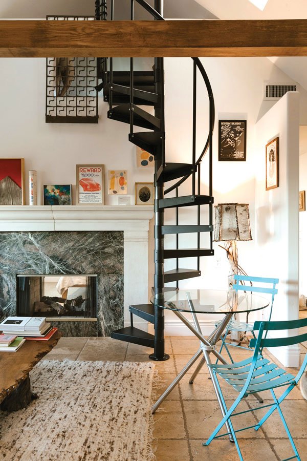  A&nbsp;spiral staircase leads to a queen bed loft in the Leonora Carrington Suite. 