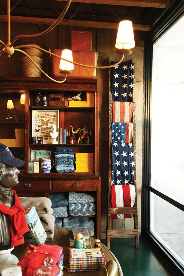  A corner features vintage flags, books, and objects. 