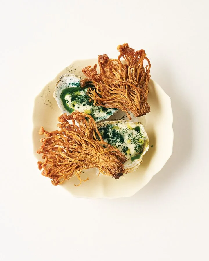 Oysters with herb beurre blanc and crisped enoki mushrooms. 