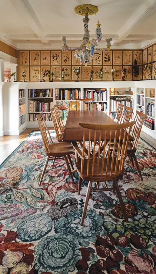  An intricate chandelier by New York artist Francesca DiMattio presides over the sleek Hans Wegner dining table surrounded by minimalist wooden chairs by George Nakashima. 
