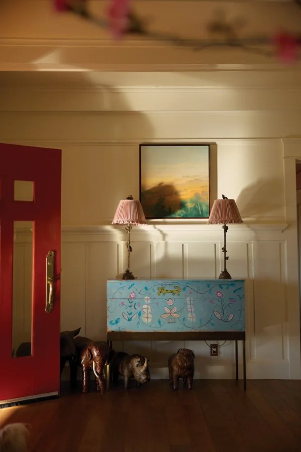  inside the front door, a Beatrice Wood chest hosts two bronze lamps by Sally Albemarle below a painting by Matthew Brown. 