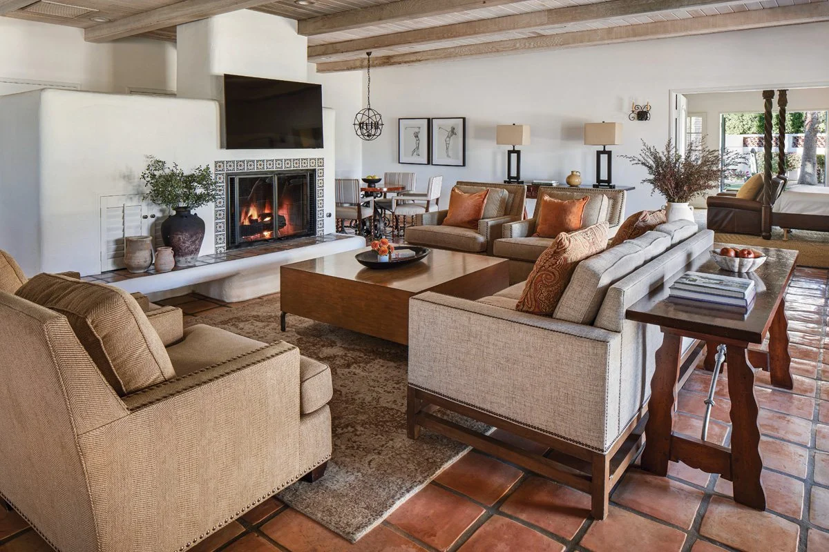  Hand-painted tiles, exposed wood beams, and travertine-bordered fireplaces define the common spaces 