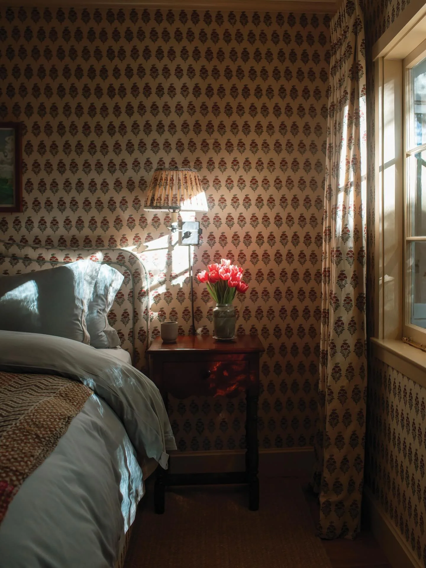 Rainy mornings and breakthrough sunshine are our favorite time of day at @ashleyudavid home. &ldquo;This room is like a hug,&rdquo; she described. 

Pattern upon pattern upon pattern cozy up this English-style guest bedroom with wall coverings and fa