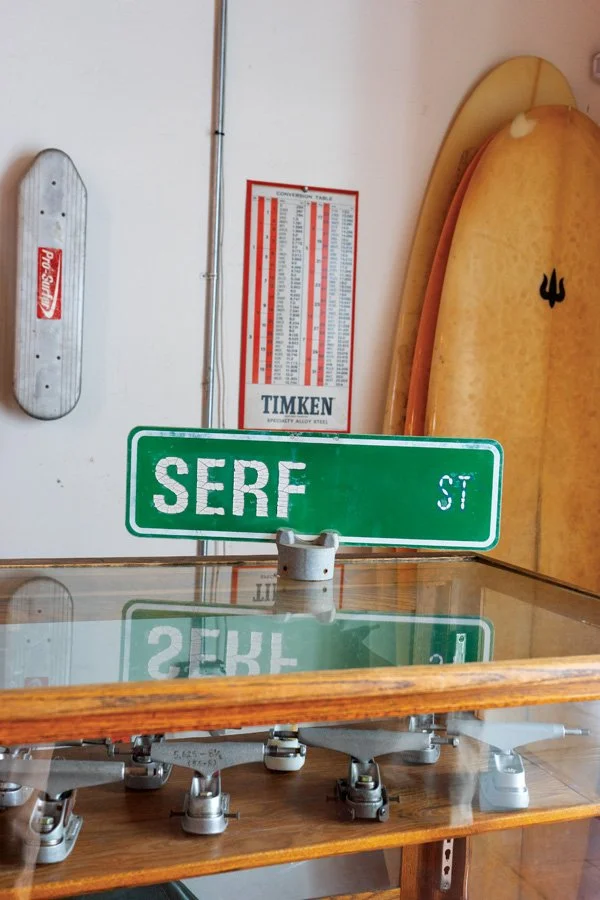  A few of Neil Stratton’s skateboard trucks under an inspirational sign. 