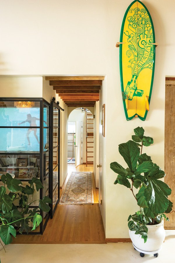 Symbols bloom on a surfboard in Leckie’s home. 