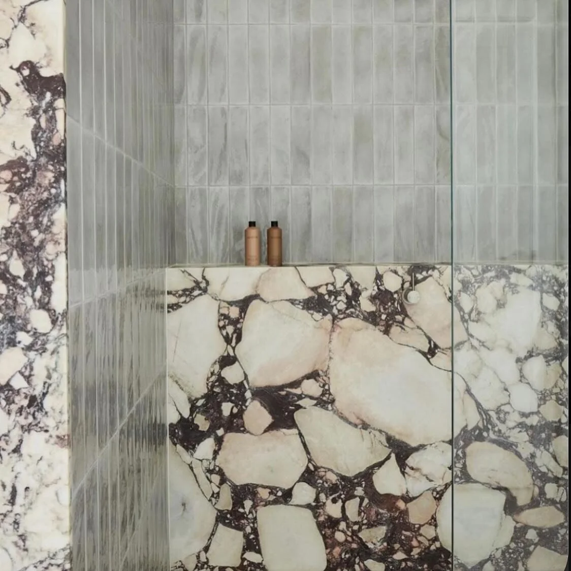 Calacatta viola carries a strong statement and is not for everyone, but this stone paired with a muted tile is gorgeous.  This beautiful bathroom is designed by @alexandrabrowninteriors