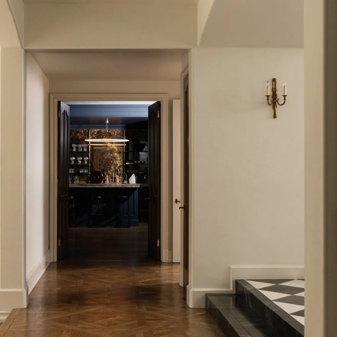 The view into the family room, illuminated by the clean lines of this Roll and Hill oval pendant.