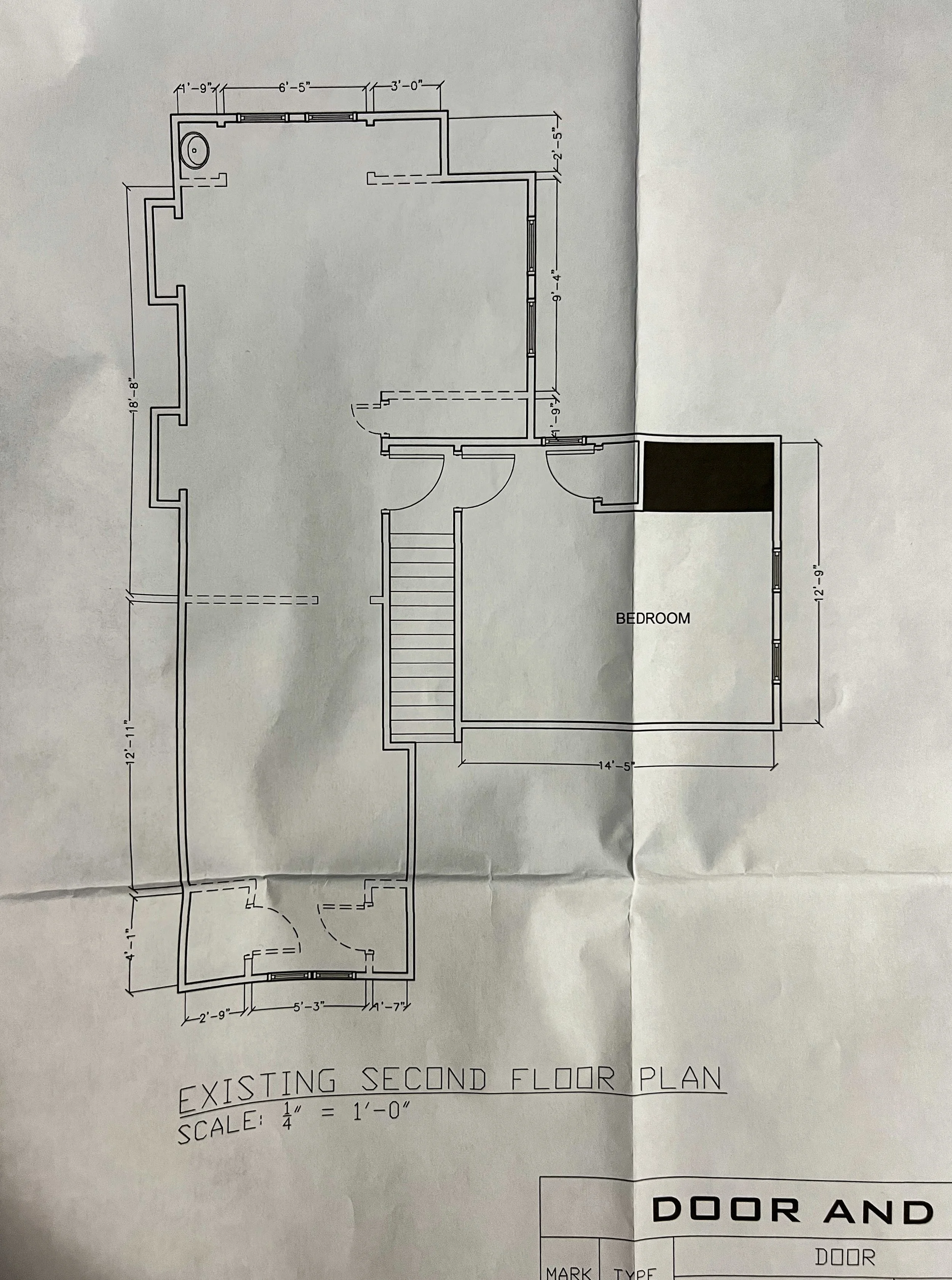 Floor plan of a second-story residence with labeled rooms, doors, and measurements, including a bedroom, stairwell, and other spaces.