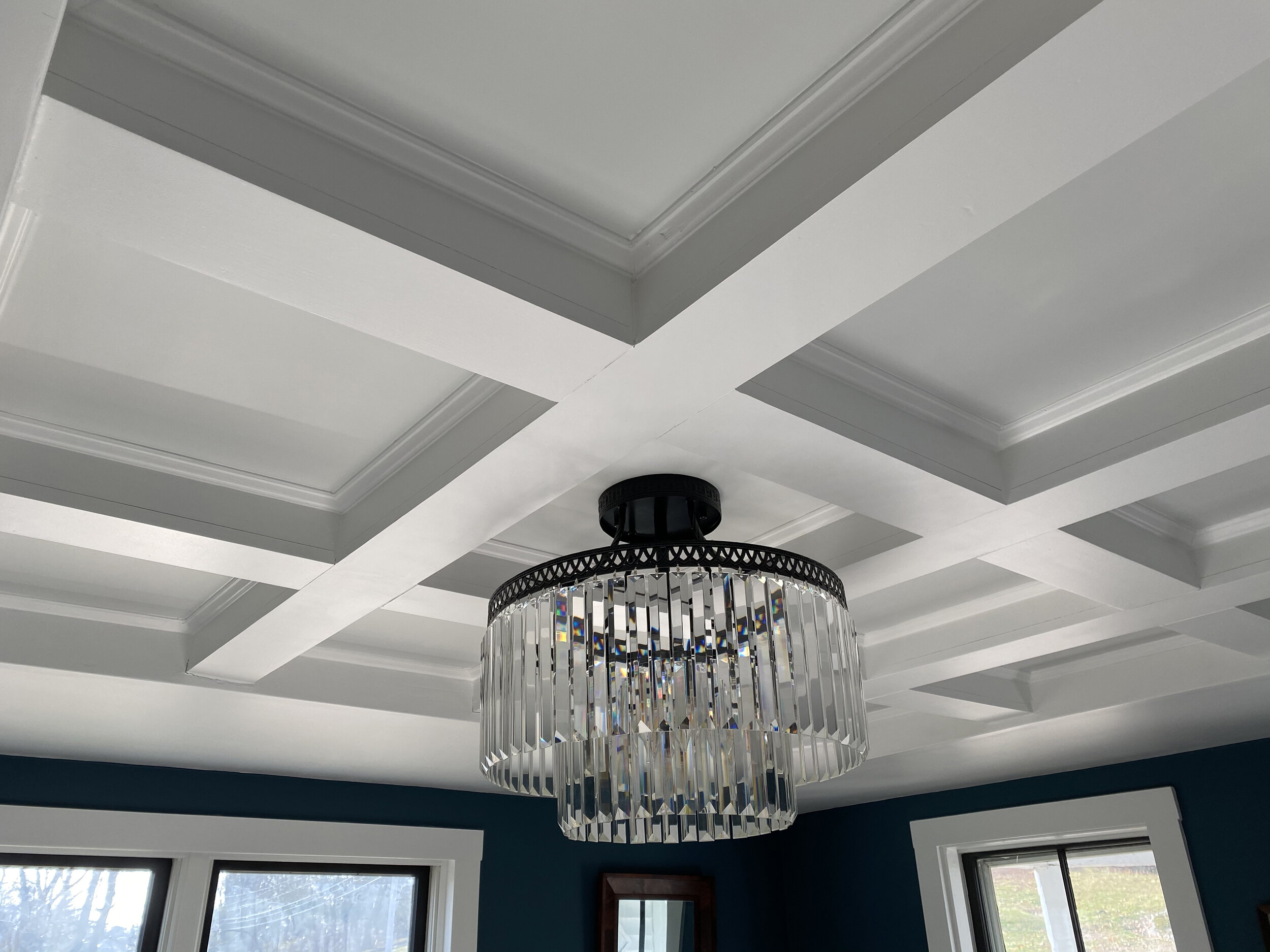 A coffered ceiling in a dining room, replacing dated drywall and recessed lighting