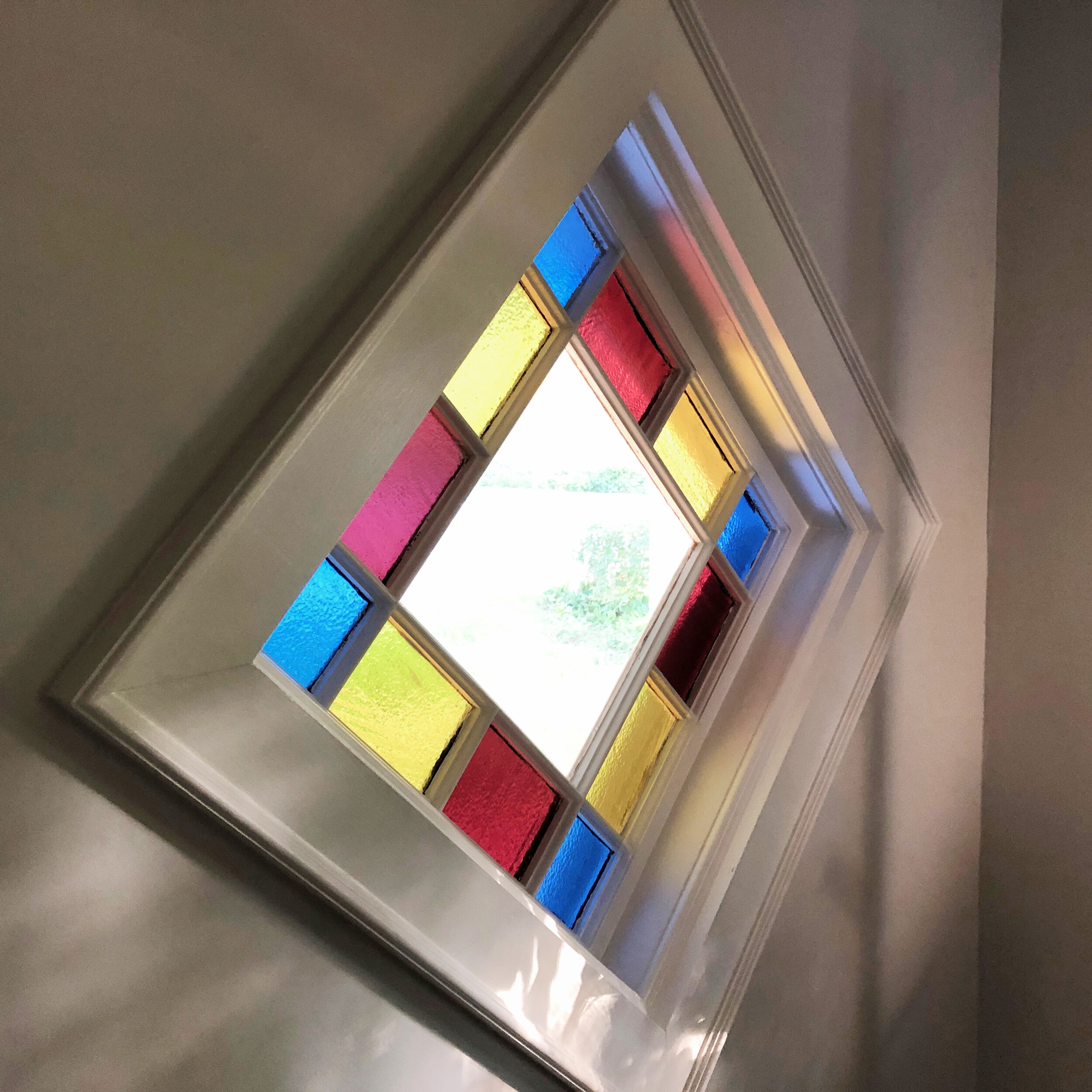 Custom molding to display an antique stained glass window