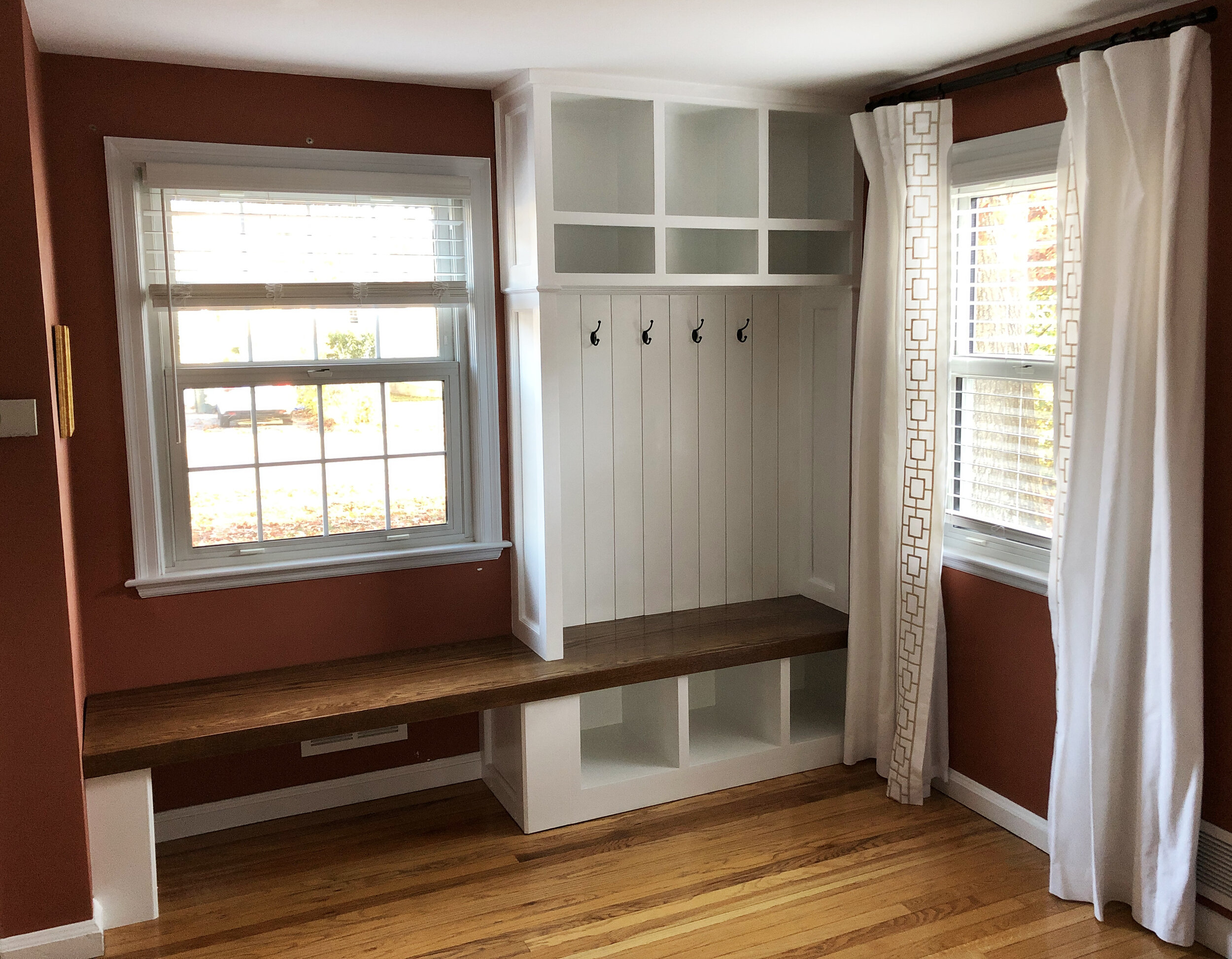 Built-in storage for coats, shoes, and backpacks tucked next to the front entry of the client's home