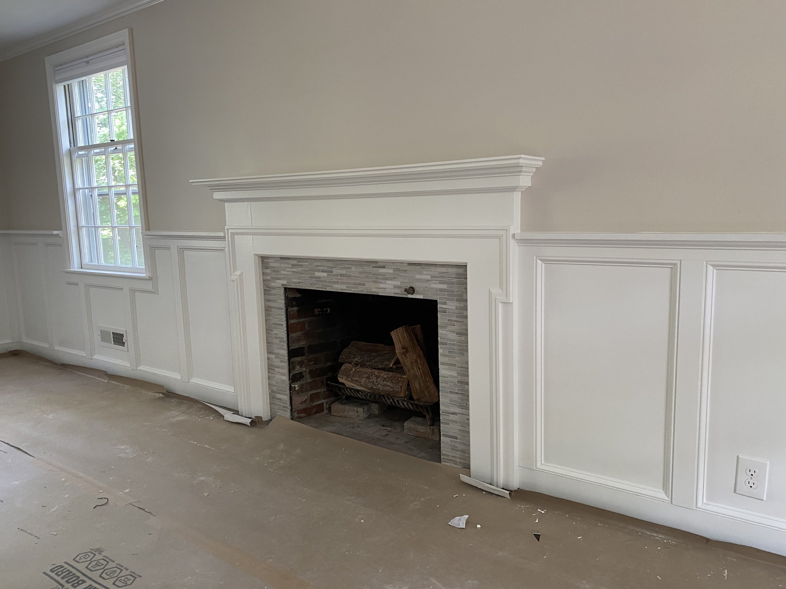 New wainscoting and an updated mantle in a formal living room.