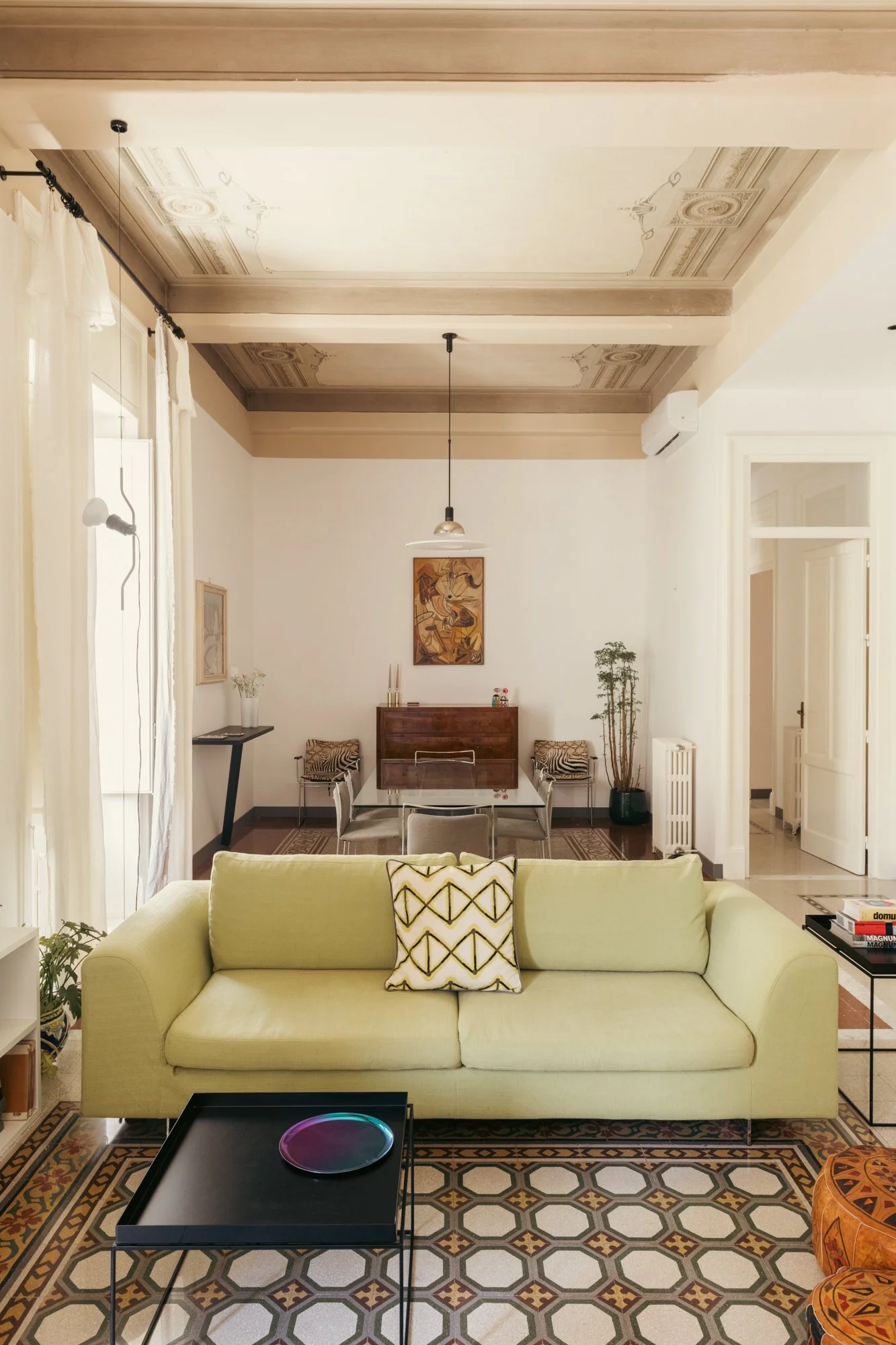 Il soggiorno dell'appartamento a Palermo  combina elementi storici restaurati e design contemporaneo, preservando l'identità originaria degli spazi abitativi.