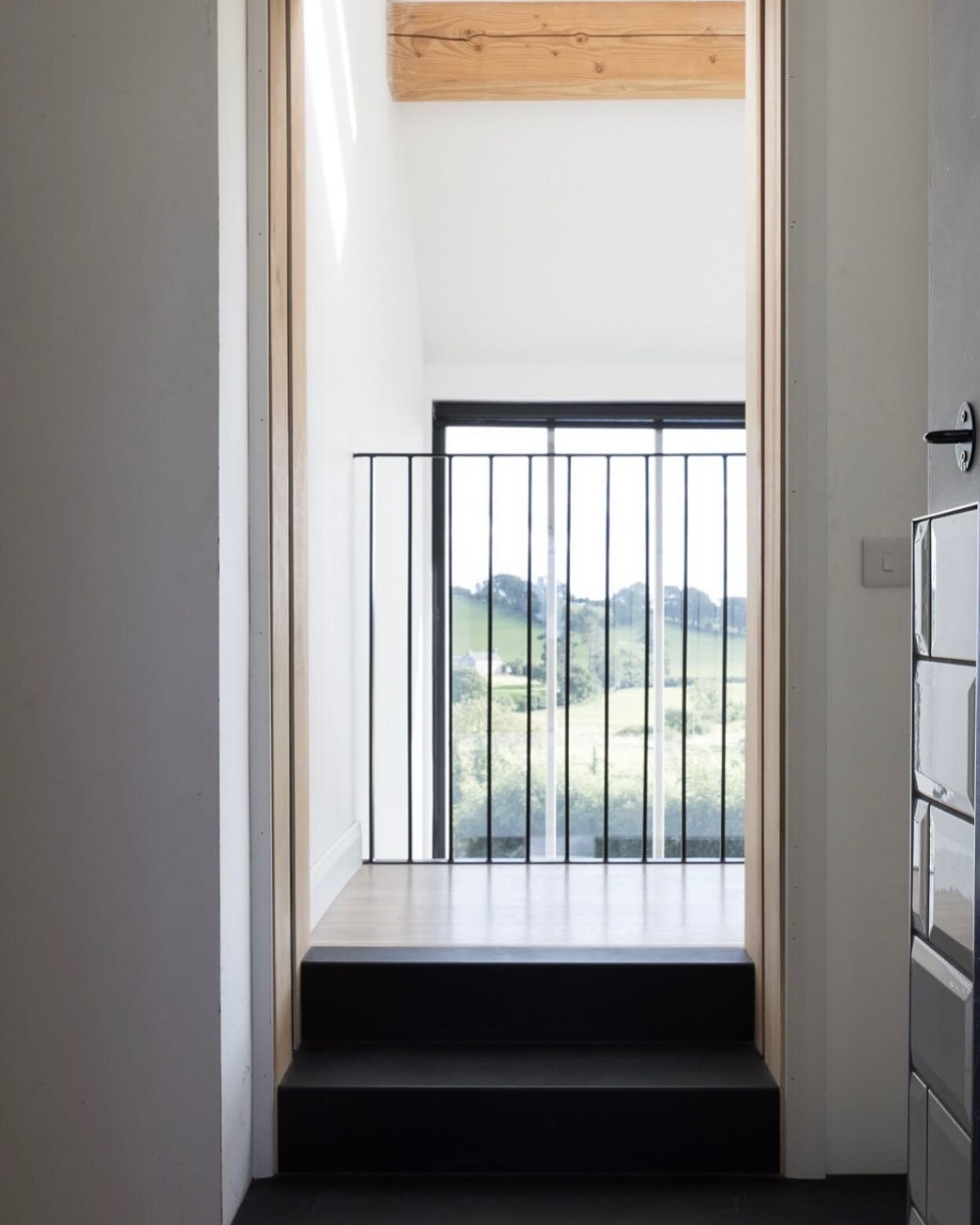 Black pressed metal steps and a ope dressed in oak, looking through to a rustic timber purlin, black metal railings and that view.
.
Keeping the materials simple, natural &amp; details elegant. Less is more.
.
#simplematerials #woodandmetal #interior