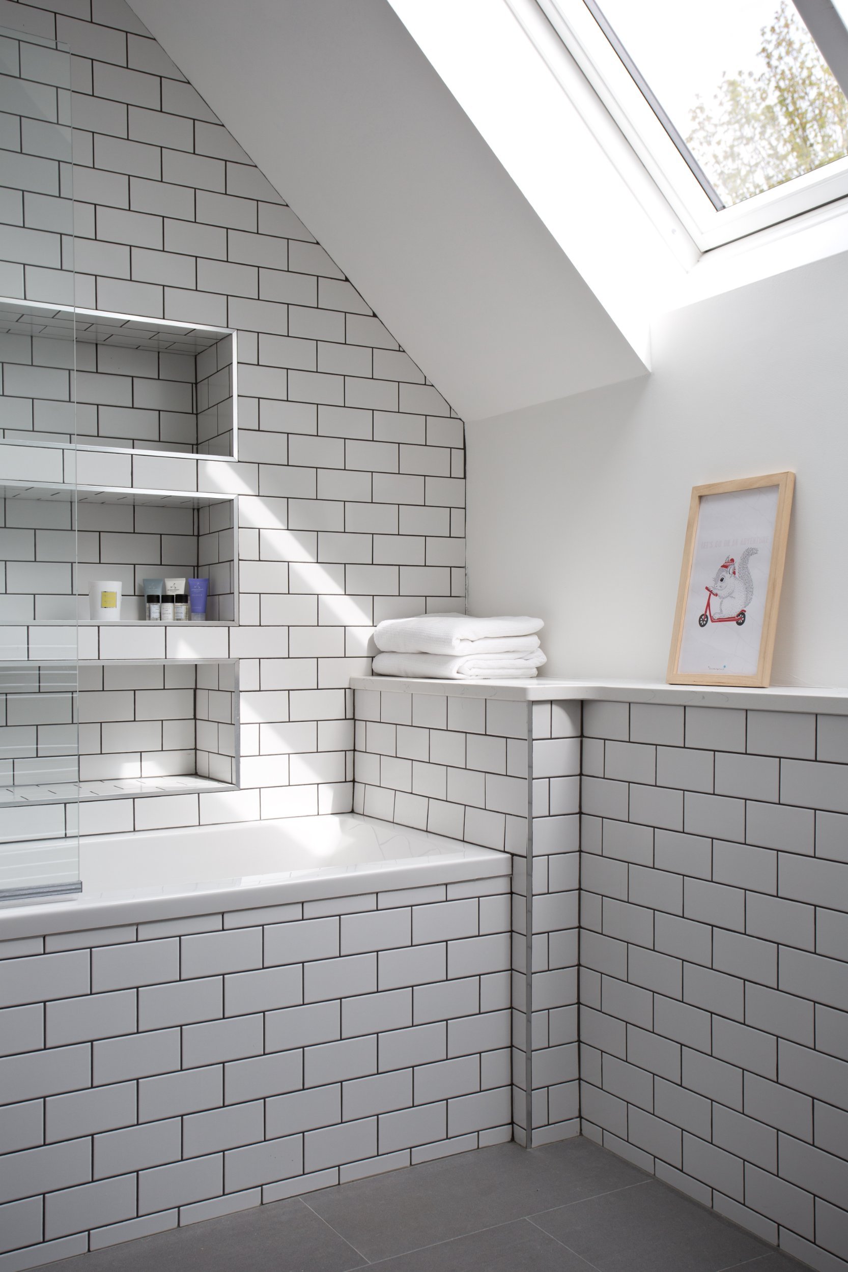 Simple white subway tile with dark grout to bathroom by McNulty Smyth Associates