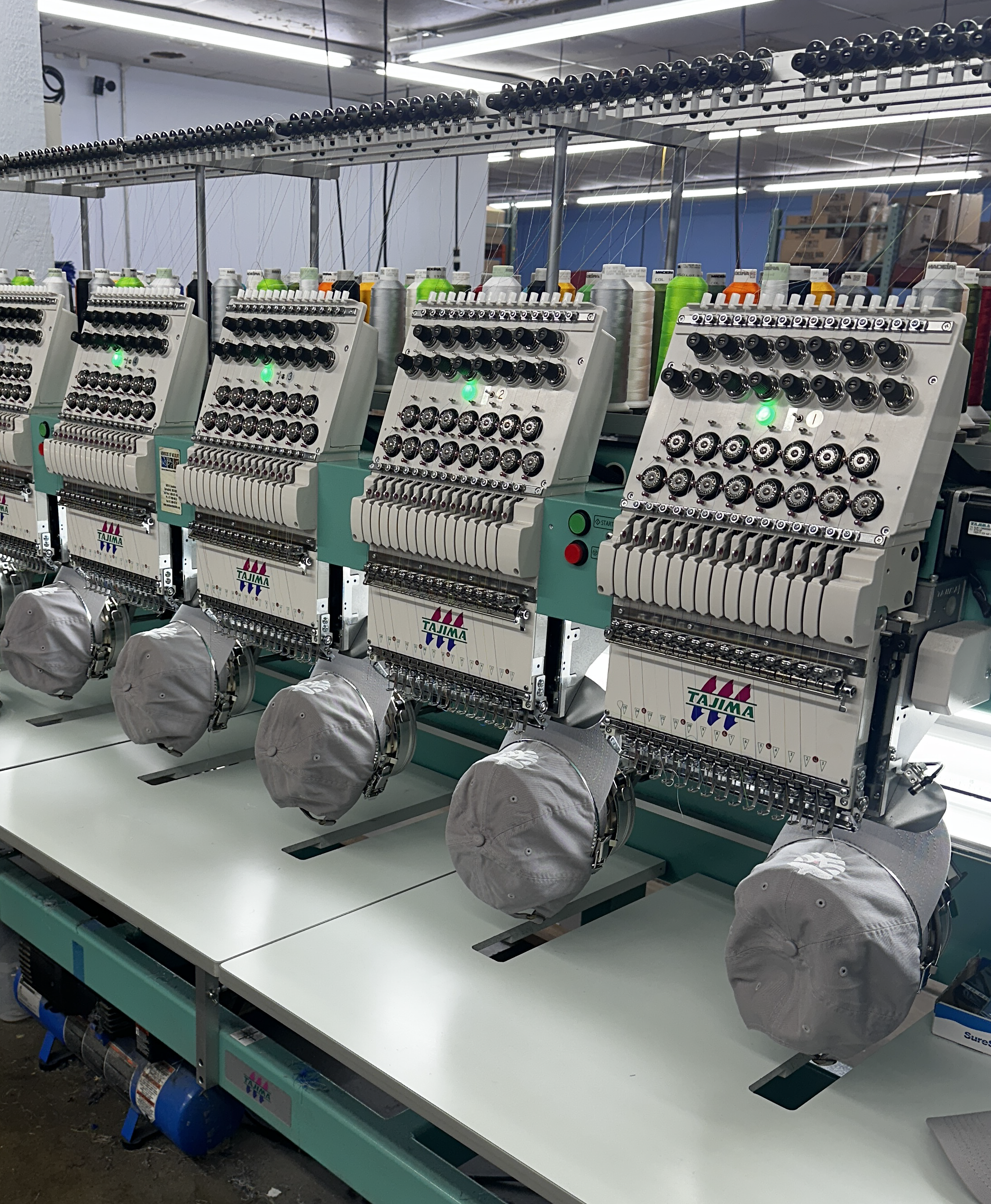 Commercial embroidery machines producing custom embroidered apparel at Empire Printing in Springfield, Missouri.