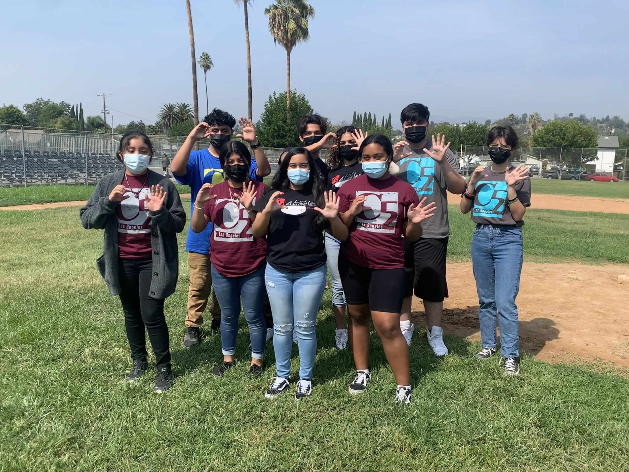 Group of high school students showing C5 sign