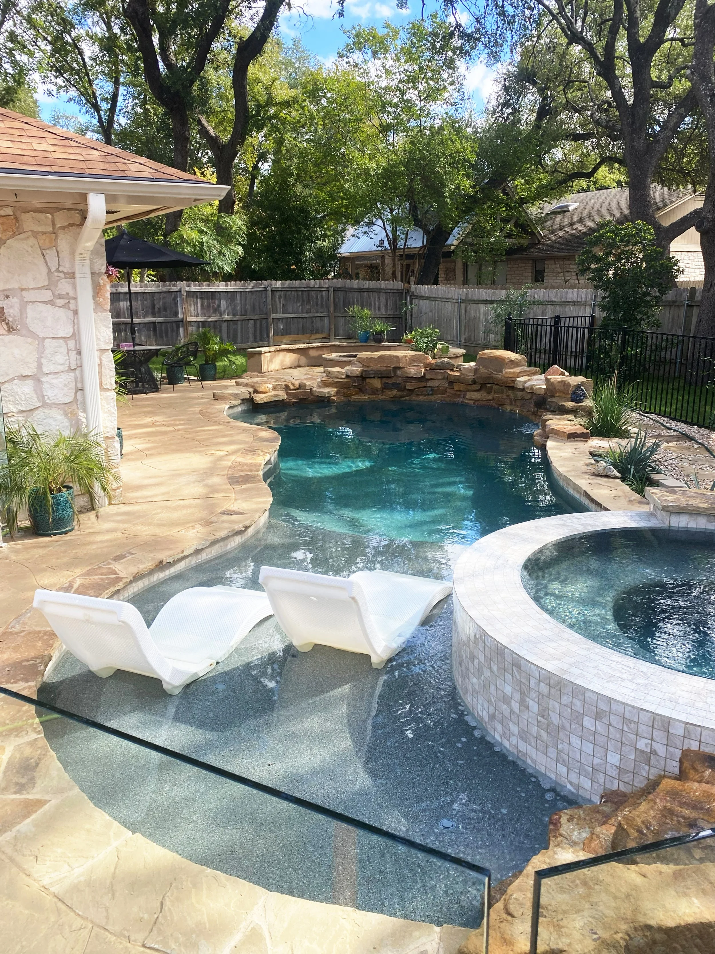Freeform pool with flagstone deck and natural rock work in Austin, TX