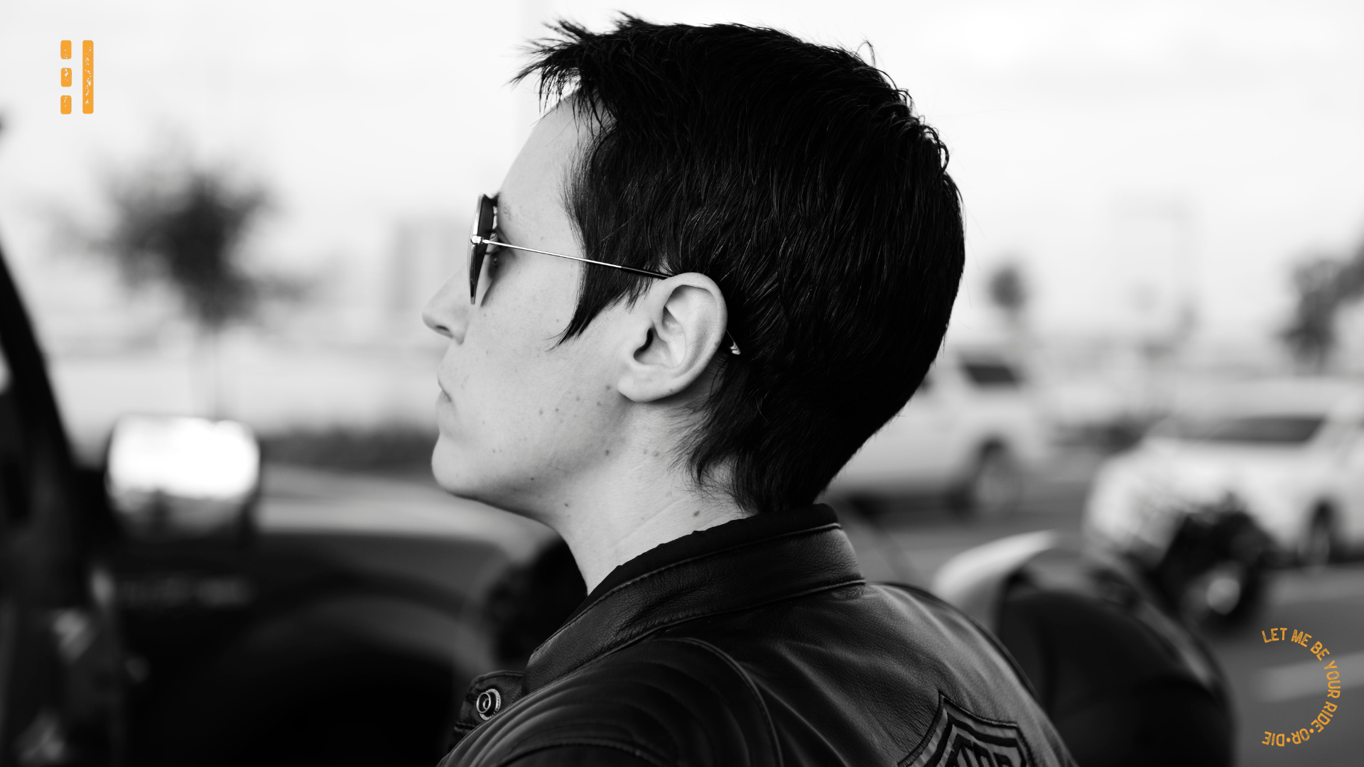 Sara, resilience guide for men, in a black and white photo in a leather jacket looking out from behind sunglasses