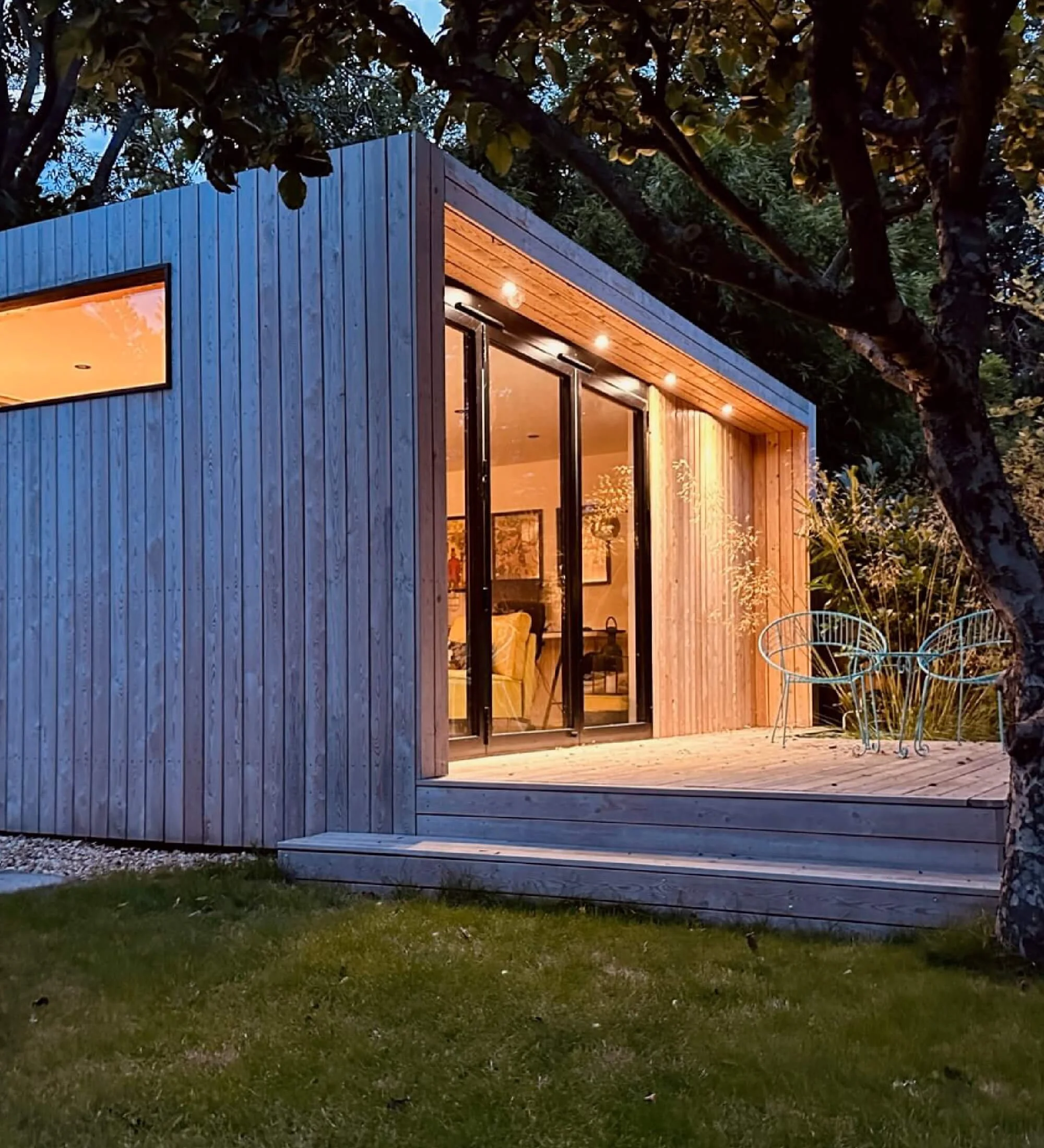 Luxury garden room in Berkshire with insulated construction and warm interior lighting for year-round use