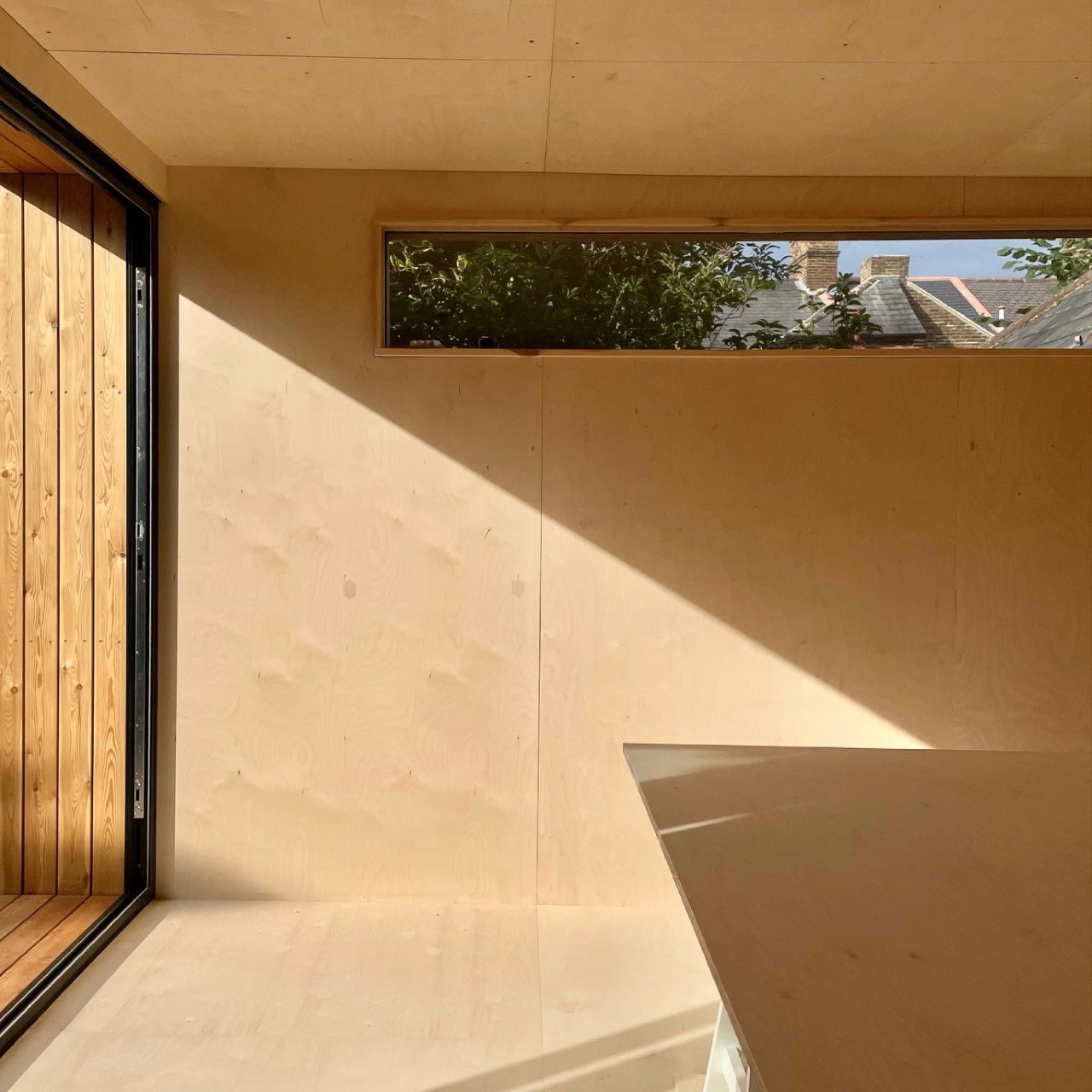 Interior view of the META 6m x 4m garden room featuring a ply-lined internal finish for a practical, workshop-style space