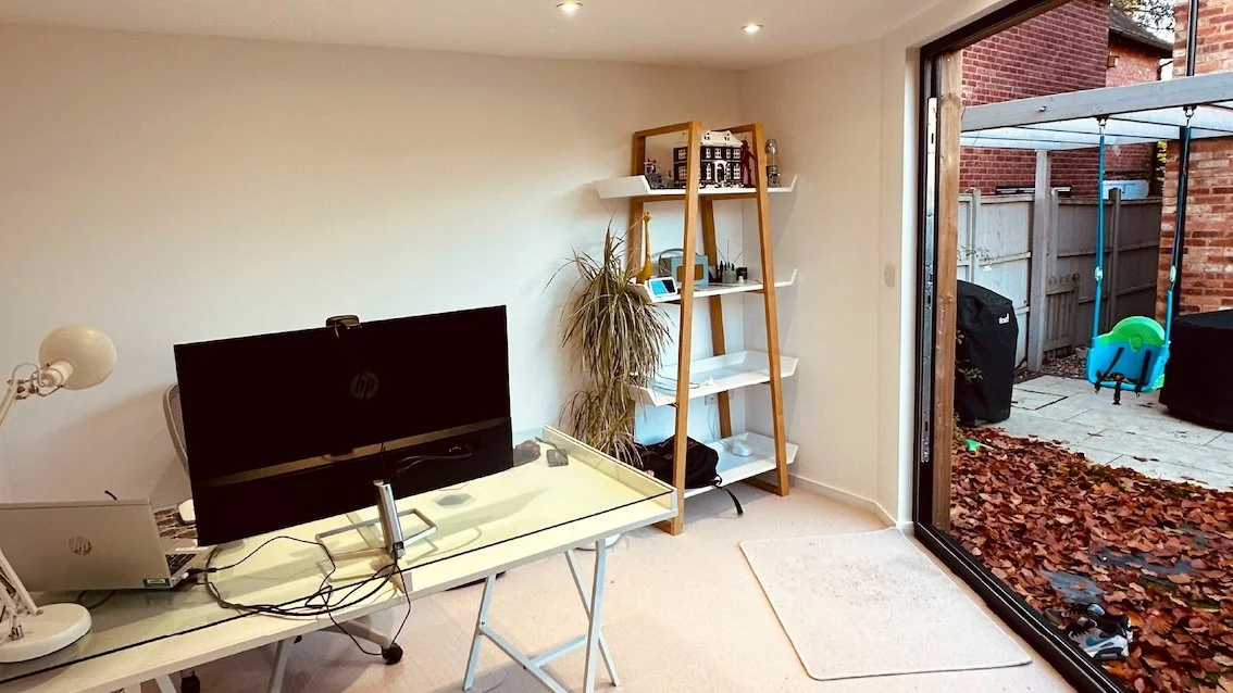 Fully finished garden office interior in Reading with a desk and comfortable year-round workspace.