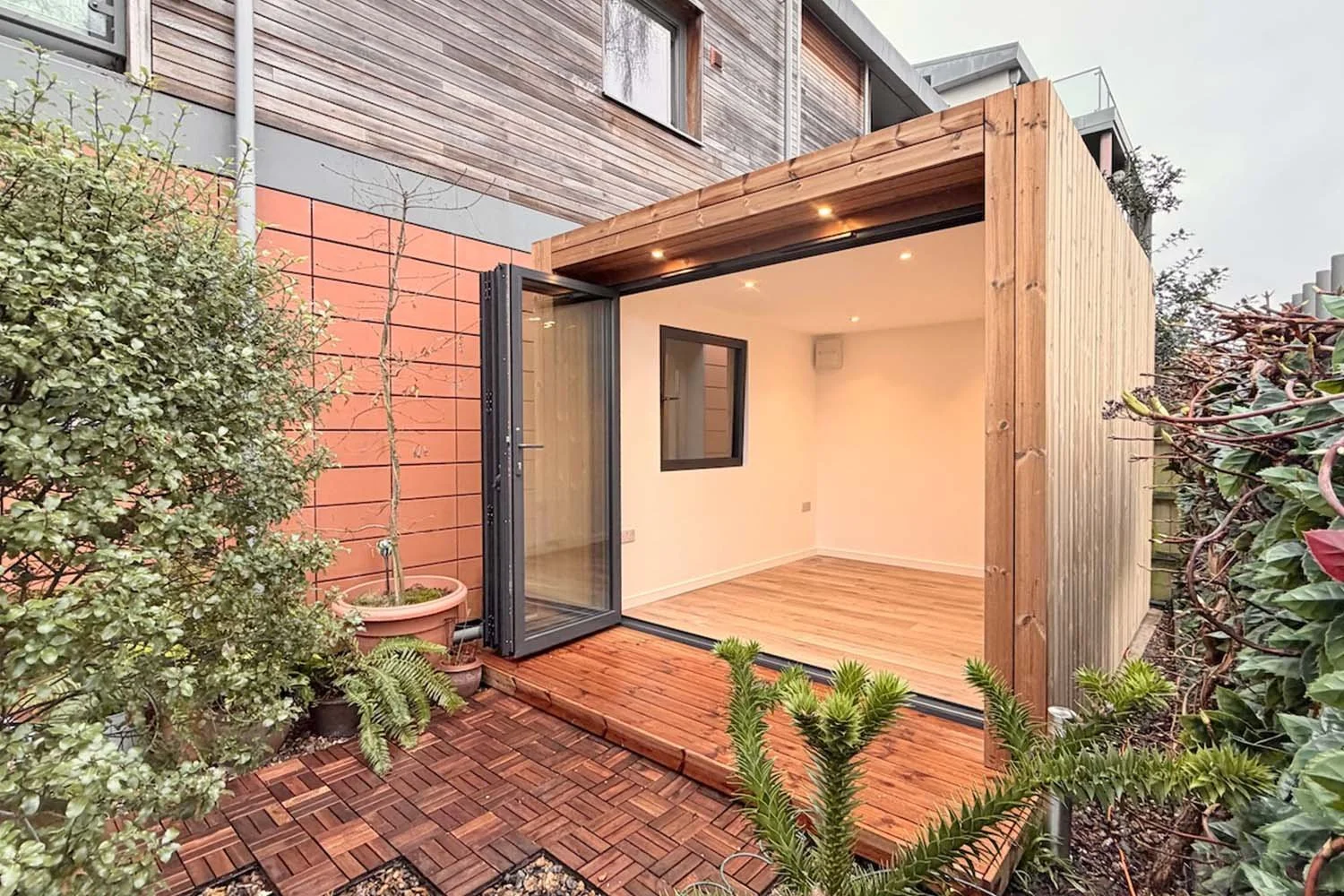 Garden room installed in a Wiltshire home garden with modern timber cladding