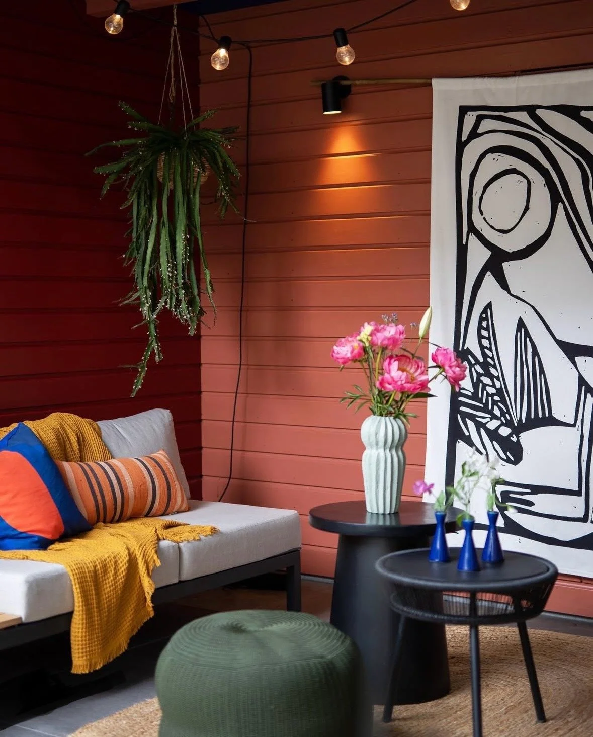 Open garden room styled with outdoor sofa seating and soft furnishings for relaxed outdoor living