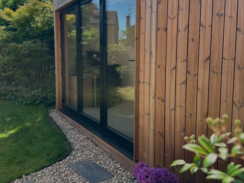 Exterior view of a bespoke angled garden office designed to fit into a corner of the garden.