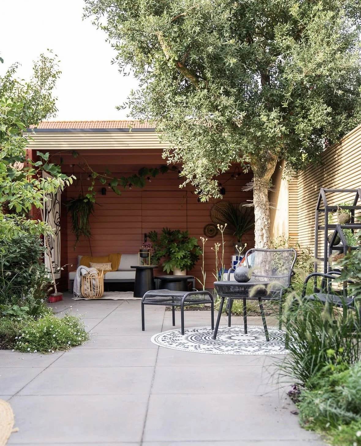 Open garden room seating area overlooking the garden with table and chairs
