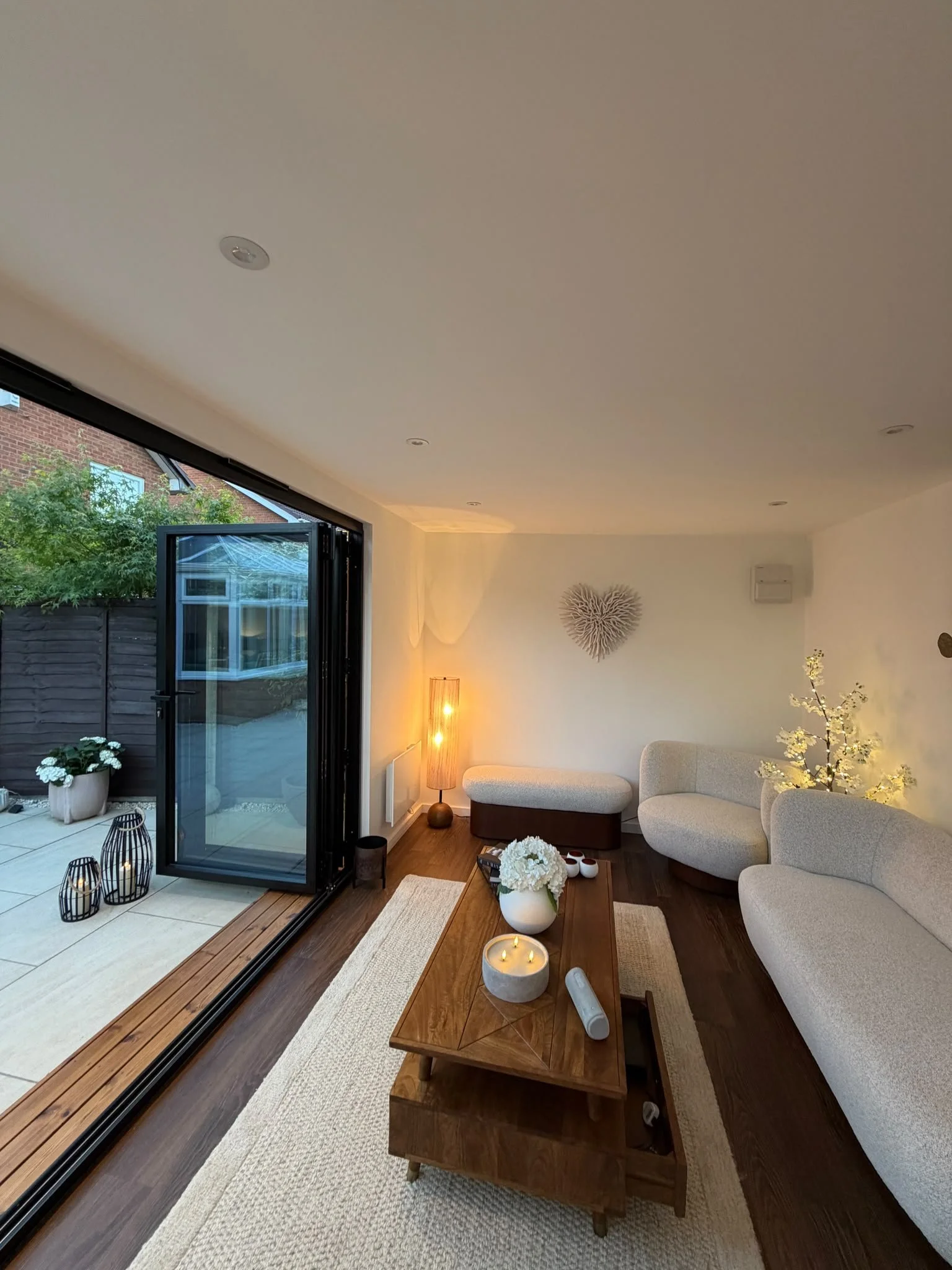 Stylish lounge inside a contemporary insulated garden room with premium finishes.