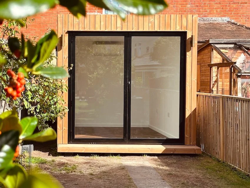 Long, narrow bespoke garden room designed to fit the available garden space.