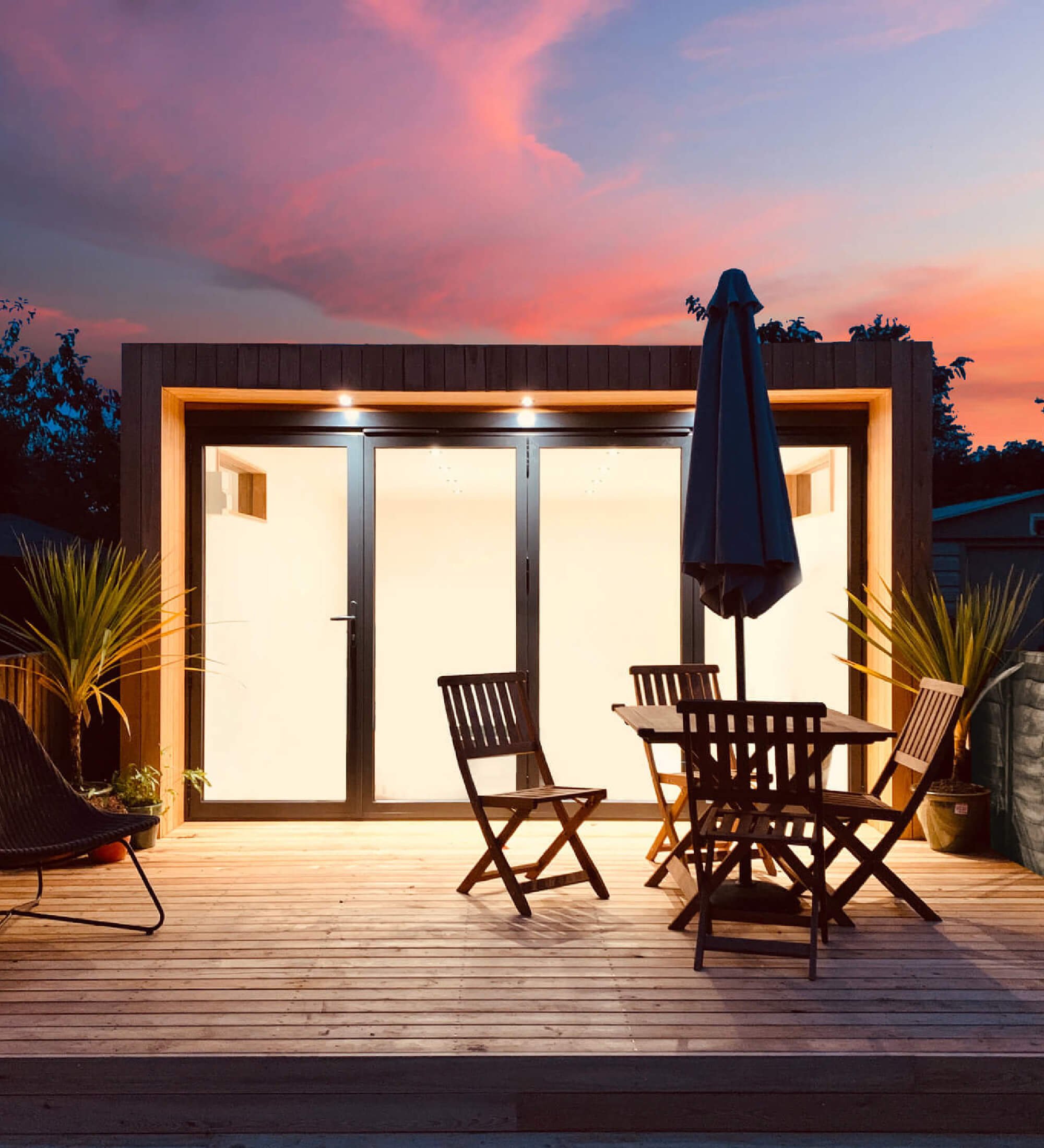 Luxury garden room with timber cladding and bi-fold doors, showcasing quality craftsmanship and modern design