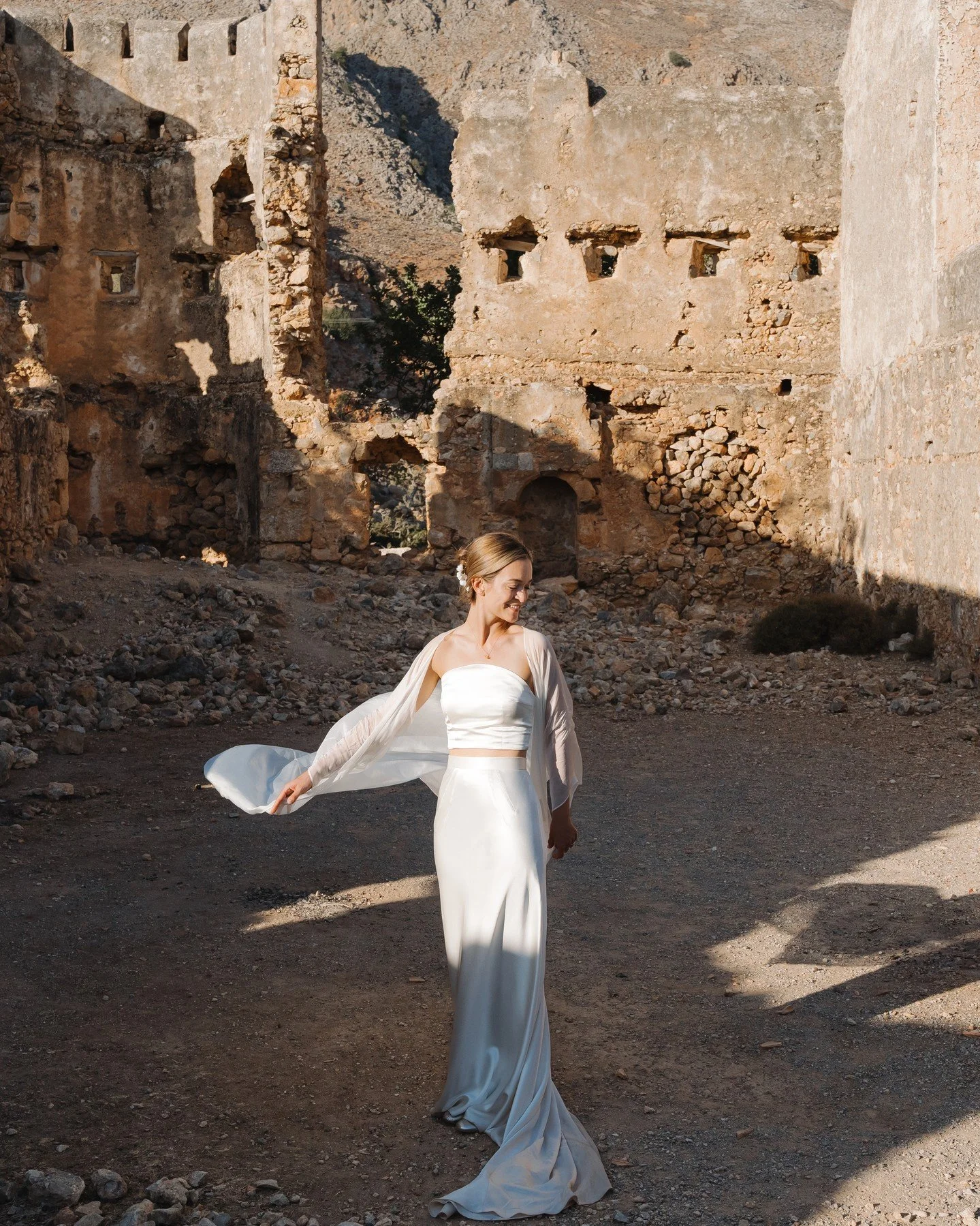 RIR bride Grace tied the knot in stunning sun-soaked Crete, wearing our Luminary Bandeau, Desire Skirt, and Kimono Robe. Grace requested that we add buttons down the centre-back of the bandeau, and also repurposed the sash of the robe as a dramatic n