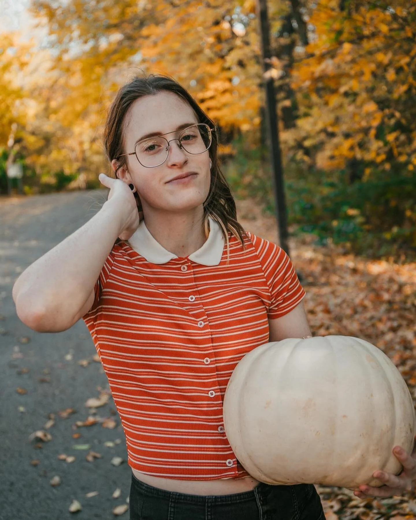 Just a girl and her pumpkin.