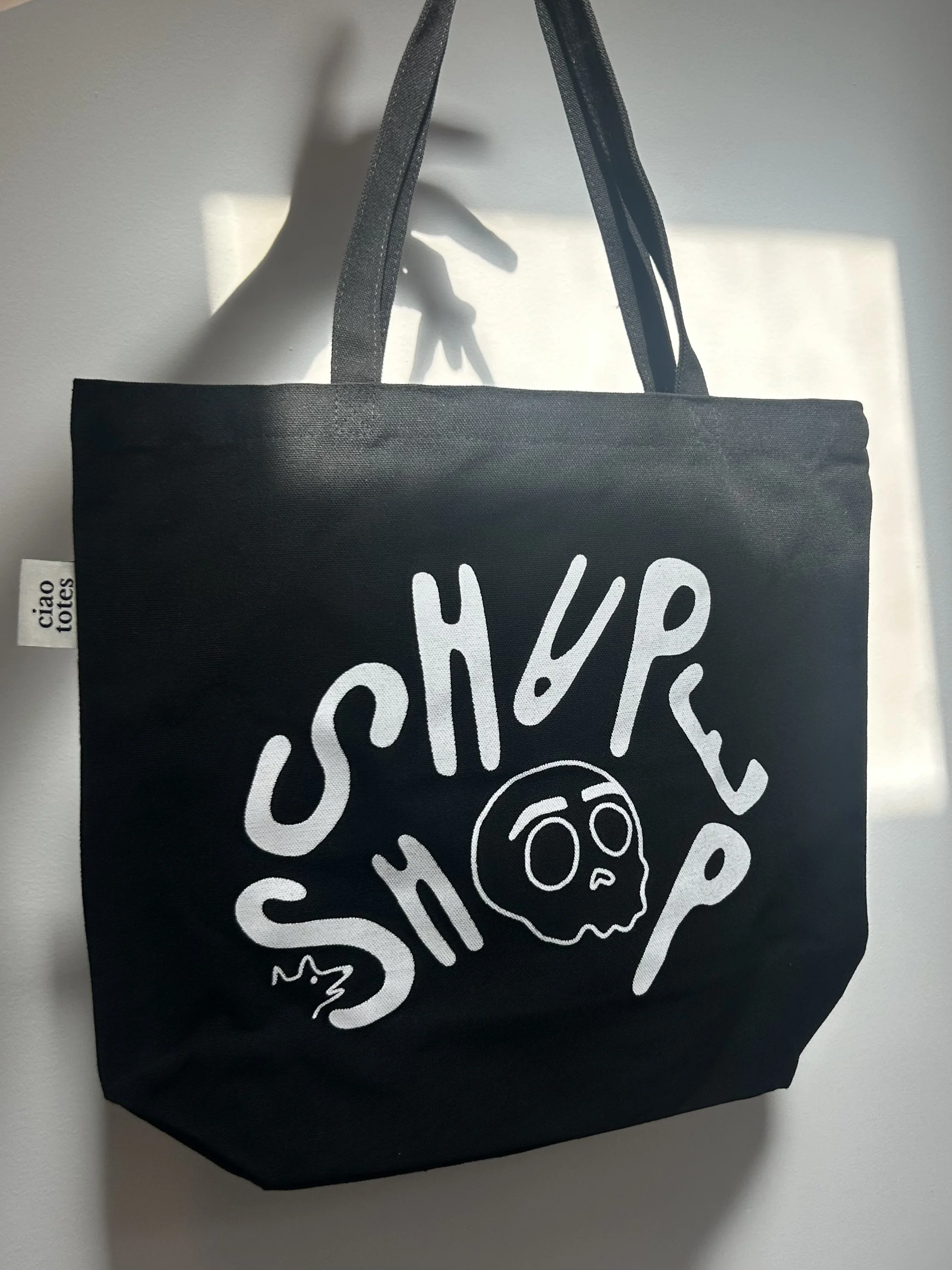 black tote hand shadow.jpeg