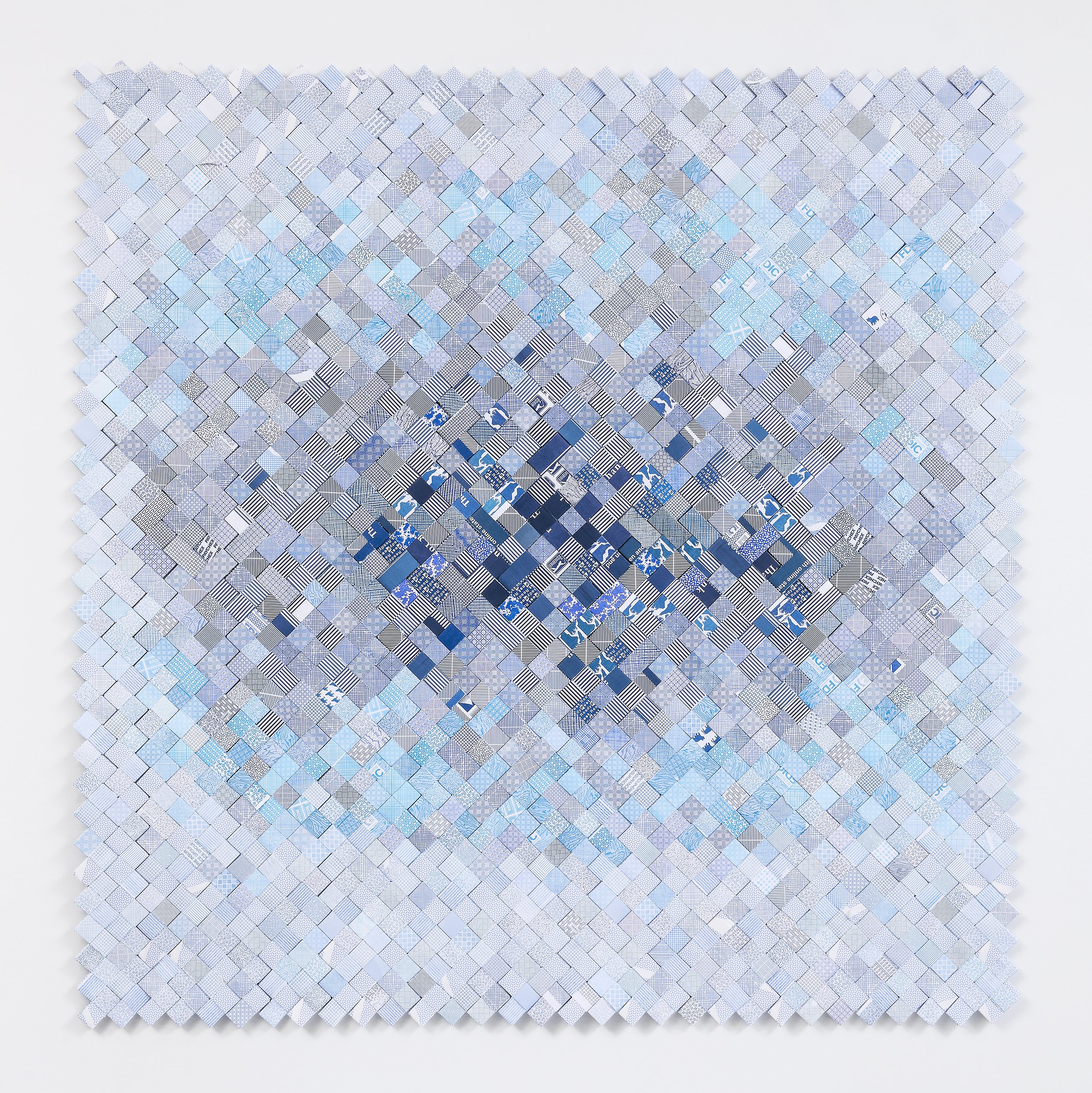 A mosaic of small square tiles in shades of blue, gray, and white arranged in a diamond pattern.