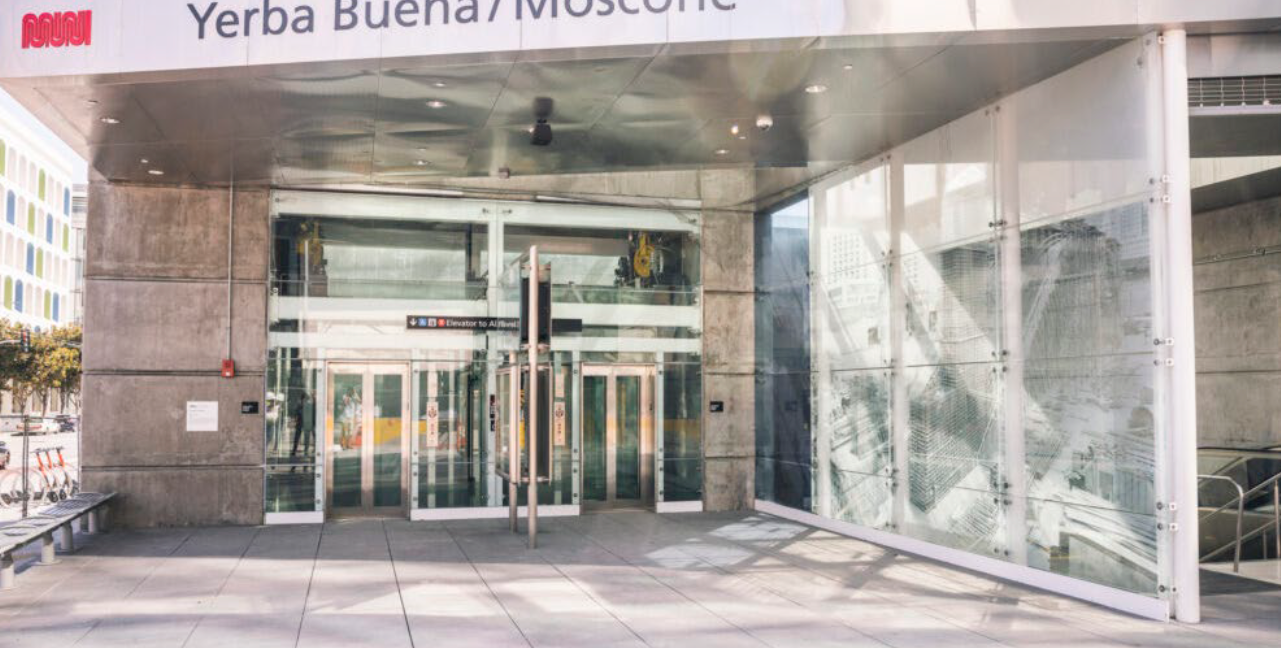 Entrance of Yerba Buena/Moscone station with glass doors and a sign overhead, located in San Francisco, California.