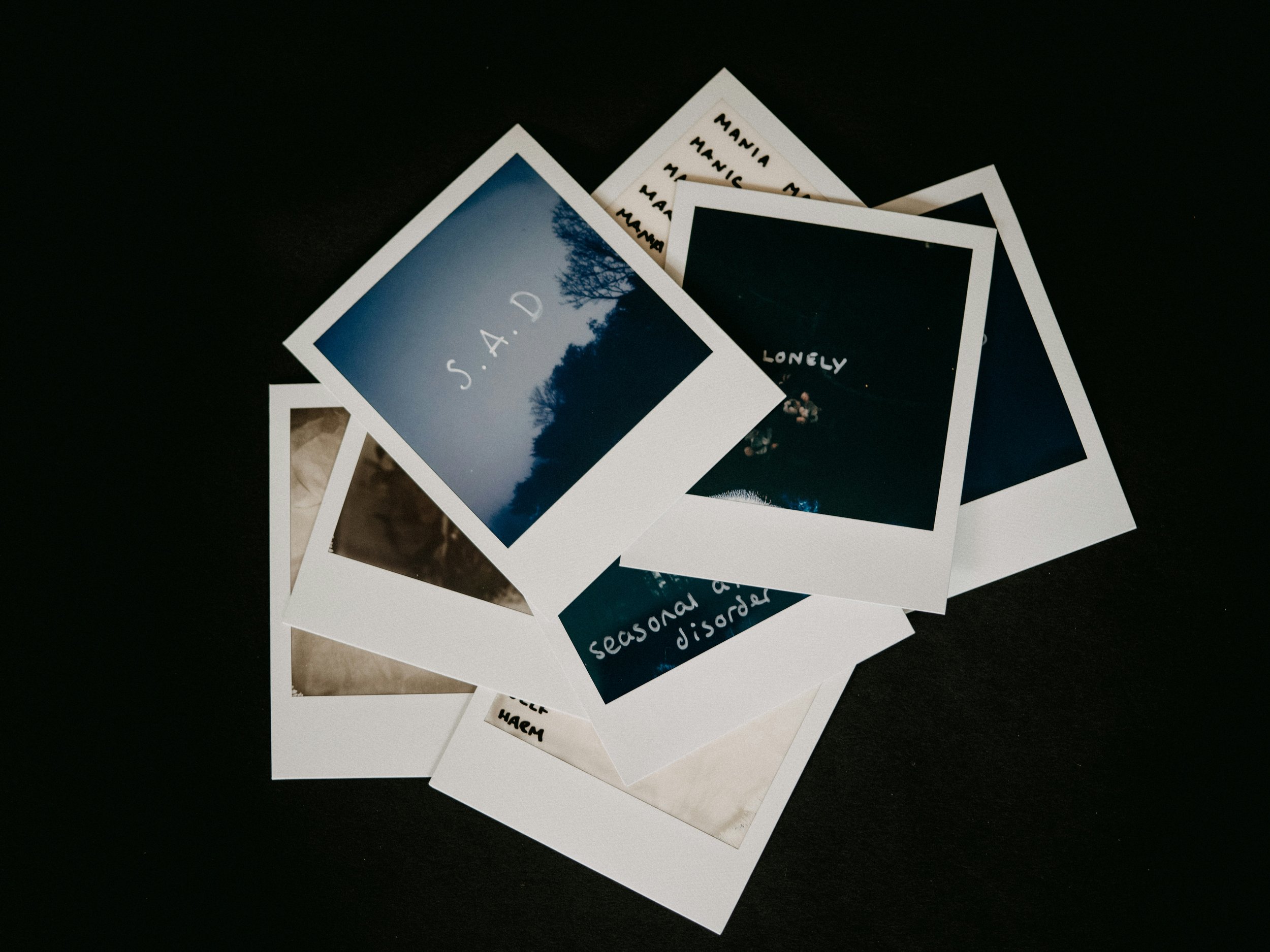 Polaroid pictures with feeling words on them.