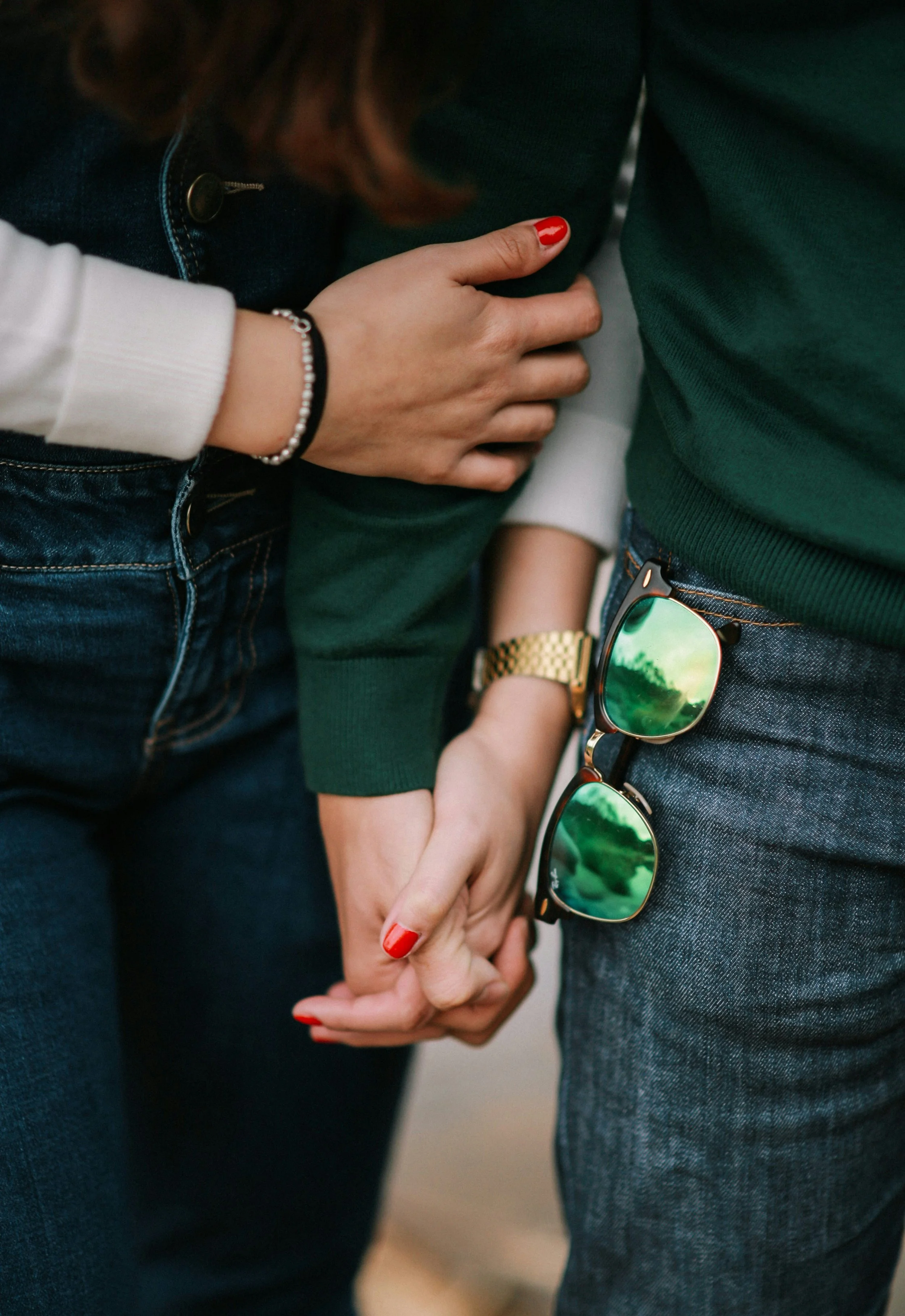 Image of a gay women couple holding hands because of EMDR therapy in Seattle.