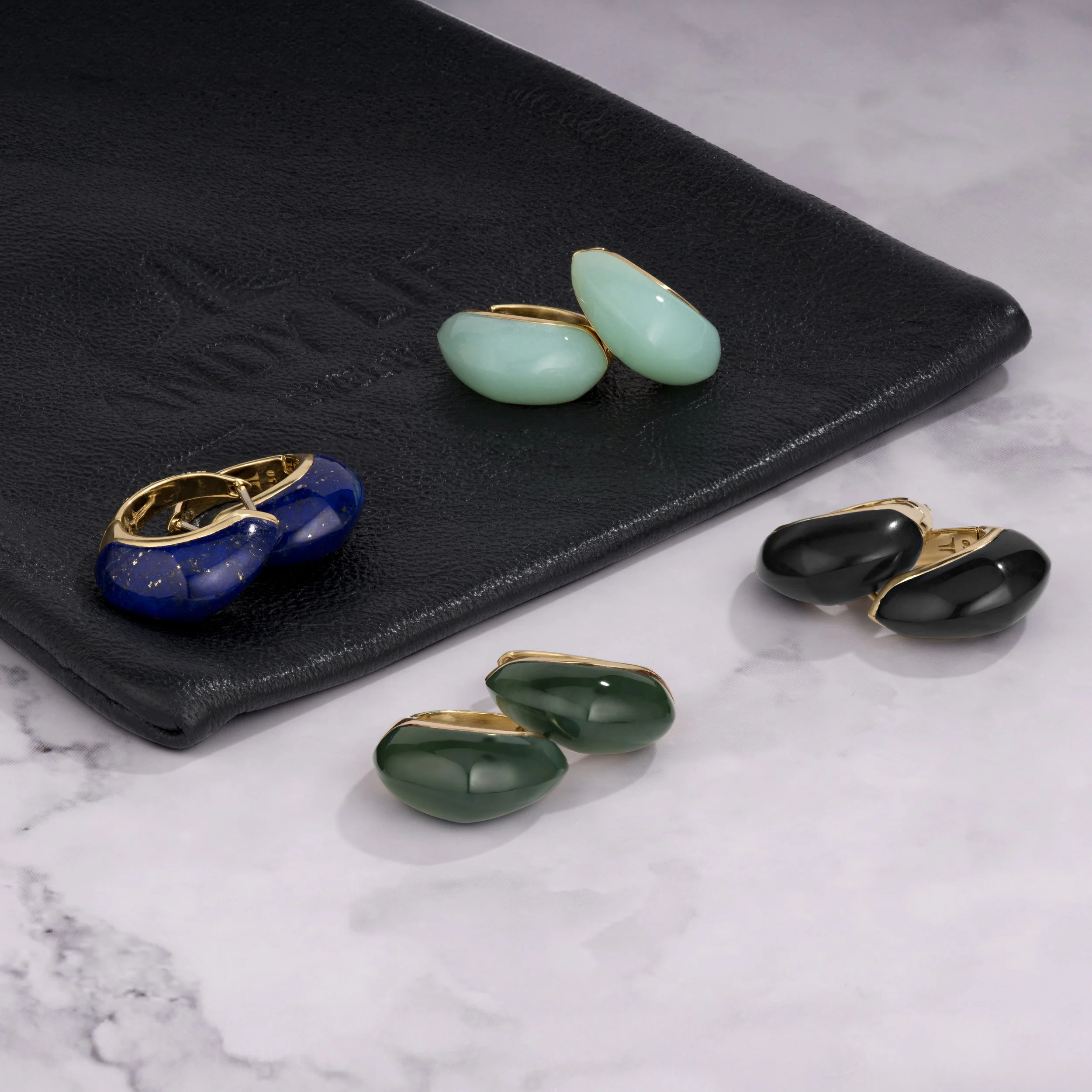 Gold and gemstone huggie earrings. 