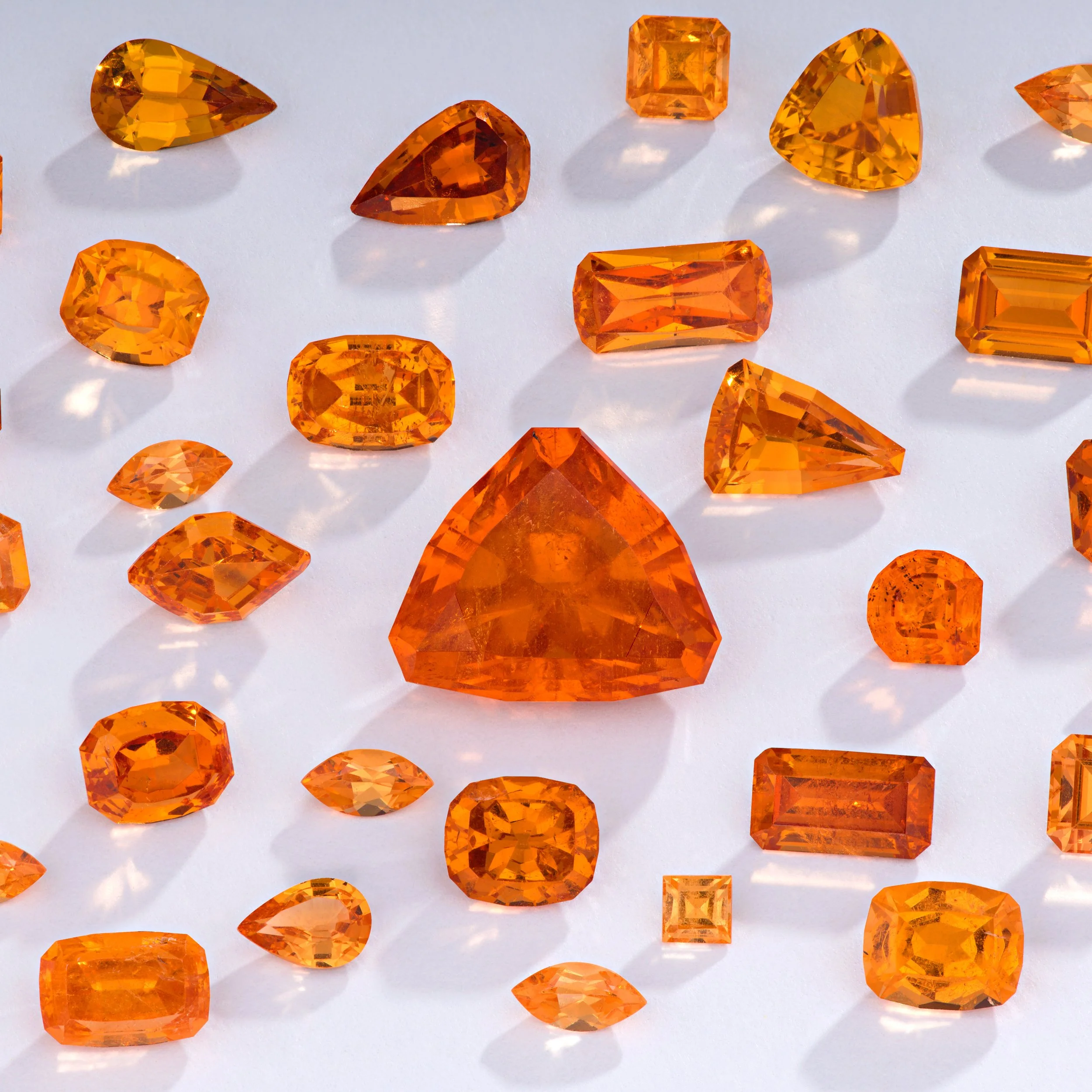 Various Melee Spessartine Garnet gems from the little three mine in San Diego. 