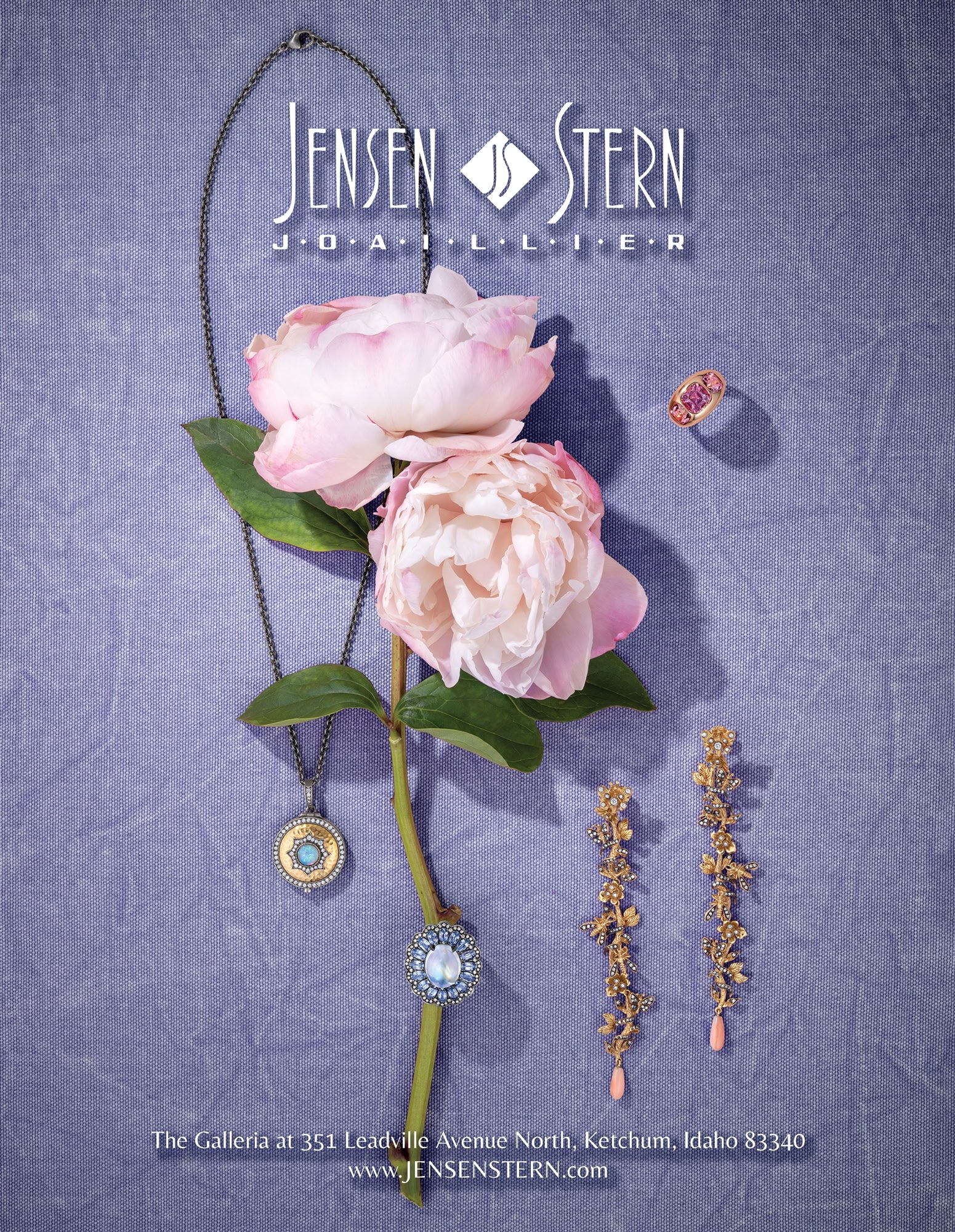 Jewelry display including a pendant necklace, a ring with pink gemstones, and two pairs of earrings with gold leaves and pink stones, arranged on a purple textured fabric alongside pink peony flowers. The text overlay provides an address in Idaho and