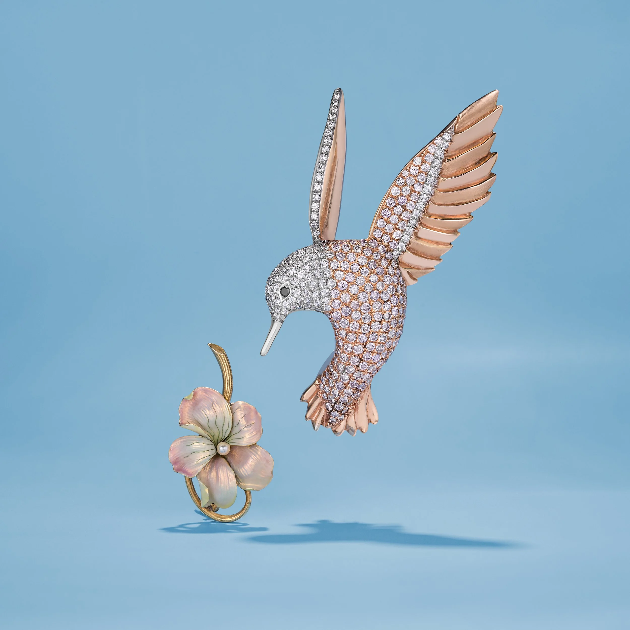 Hummingbird diamond brooch and enamel flower brooch.